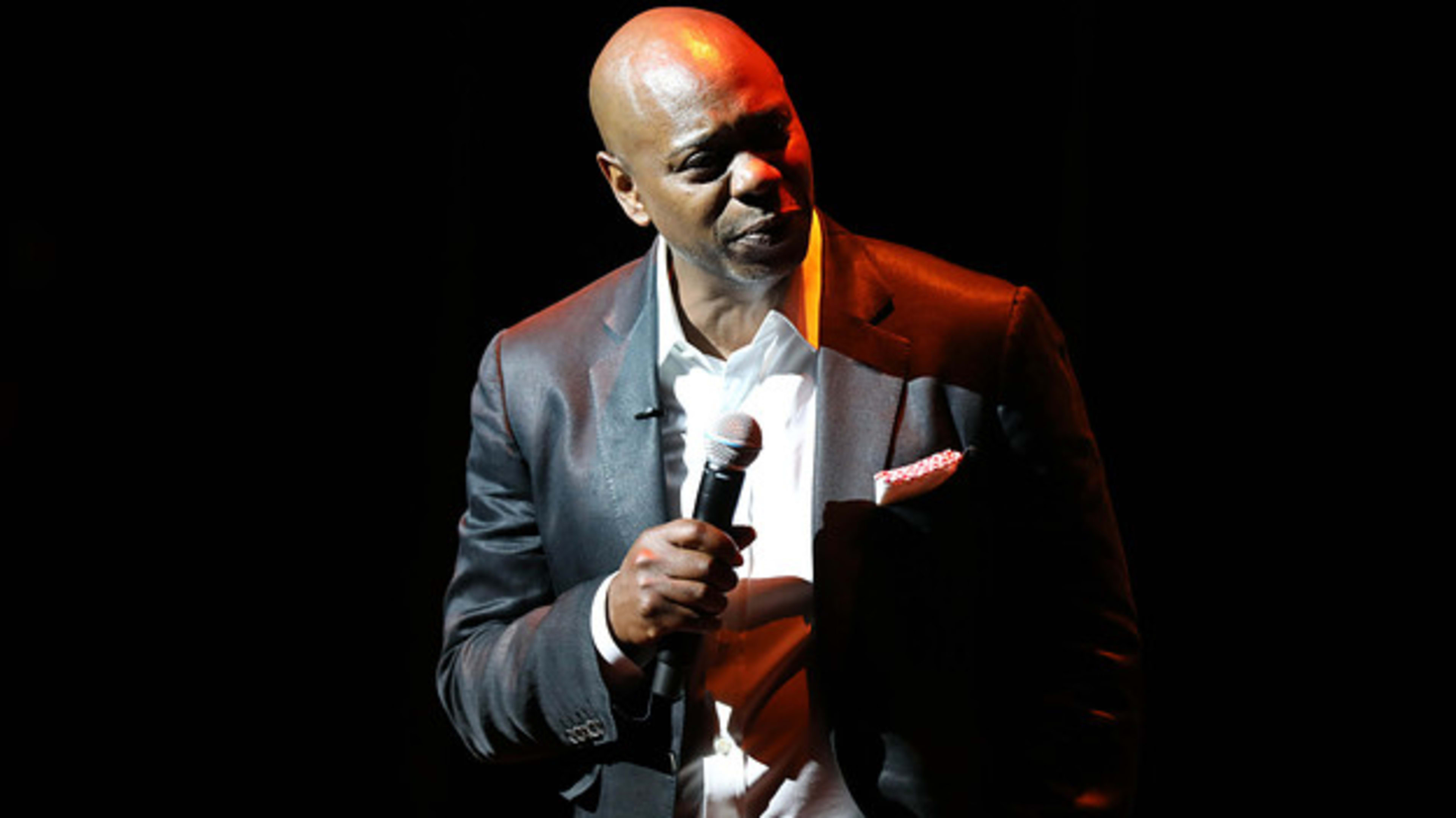 Dave Chappelle is seen giving a speech