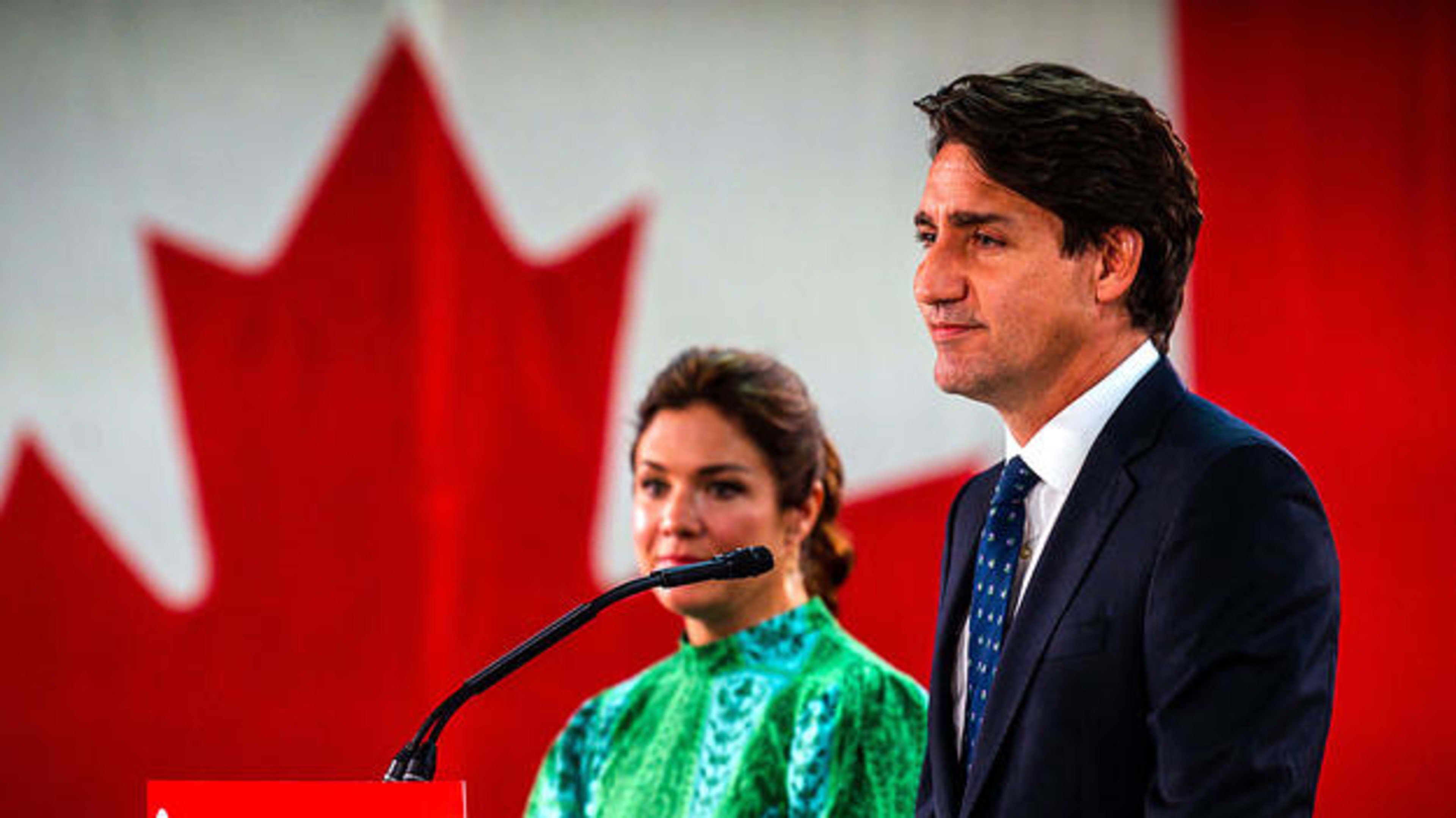 Canadian Prime Minister Justin Trudeau, flanked by wife Sophie Gregoire-Trudea, delivers his victory speech after snap parliamentary elections at the Fairmount Queen Elizabeth Hotel in Montreal, Quebec, early on September 21, 2021.