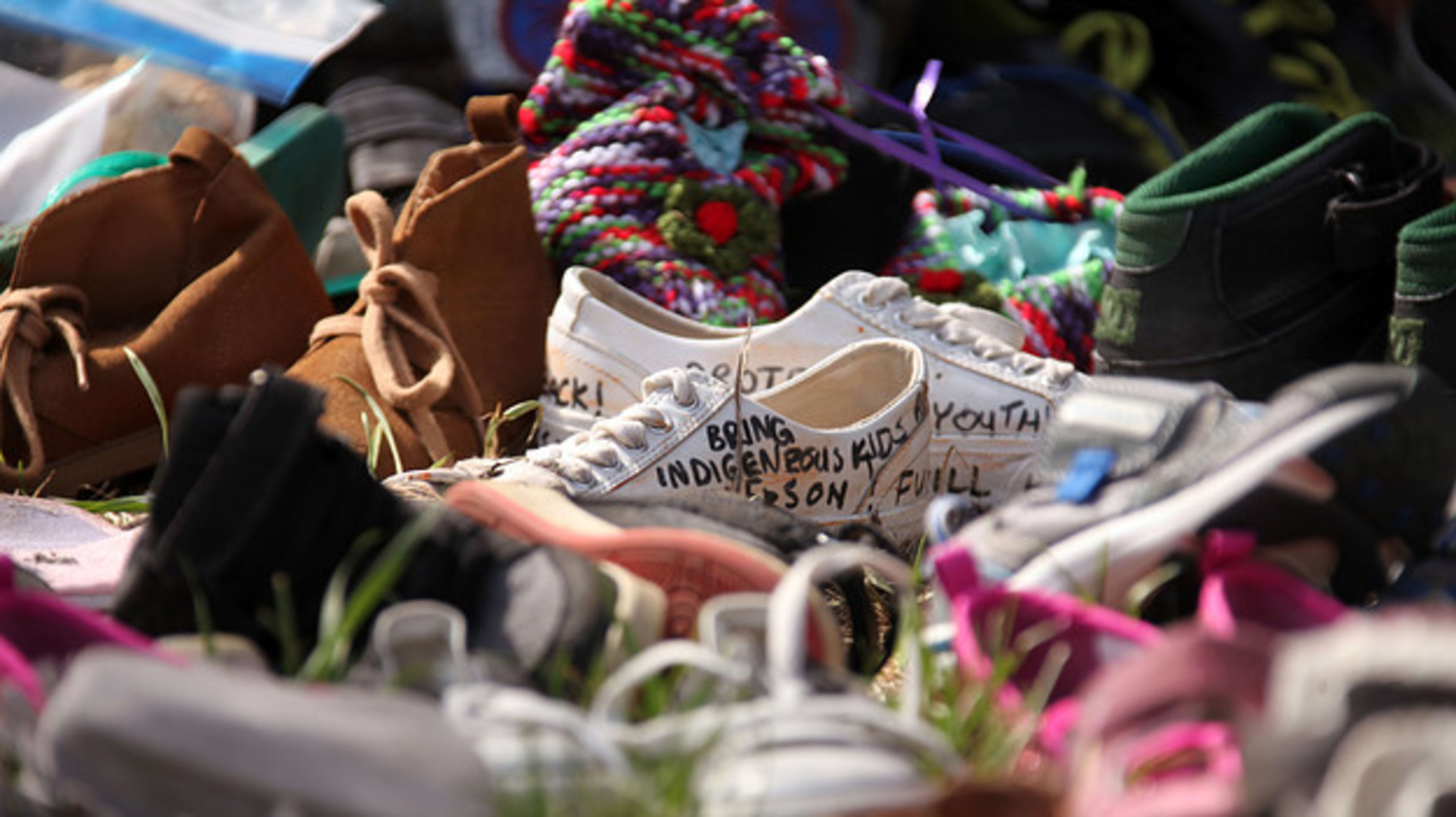 Shoes are placed at Ryerson Univerisity to mourn 215 indigenous children whose remains were discovered at a former residential school on June 7, 2021 in Toronto, Canada.