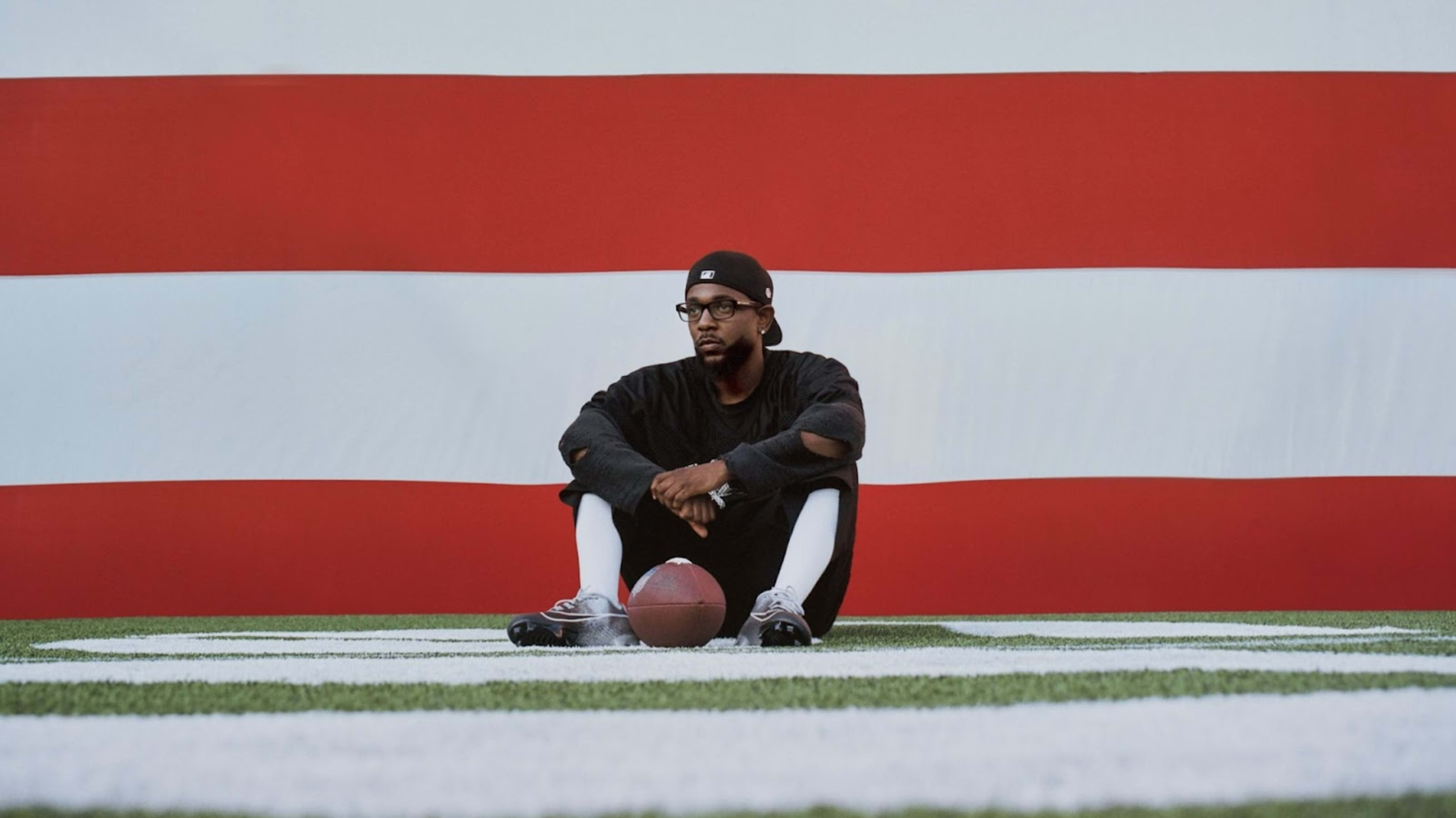 Kendrick Lamar in front of flag