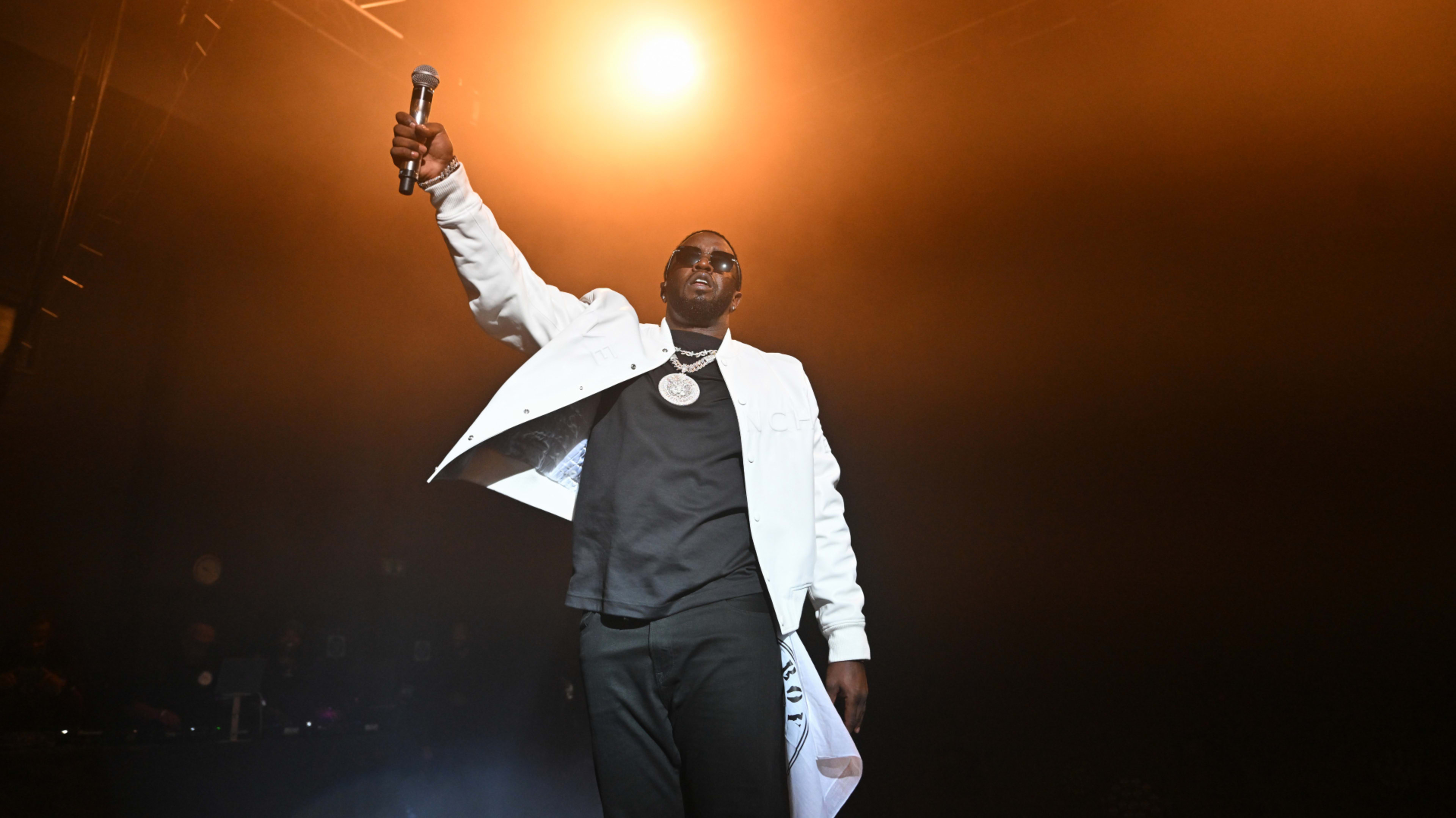 Diddy is seen holding up a mic