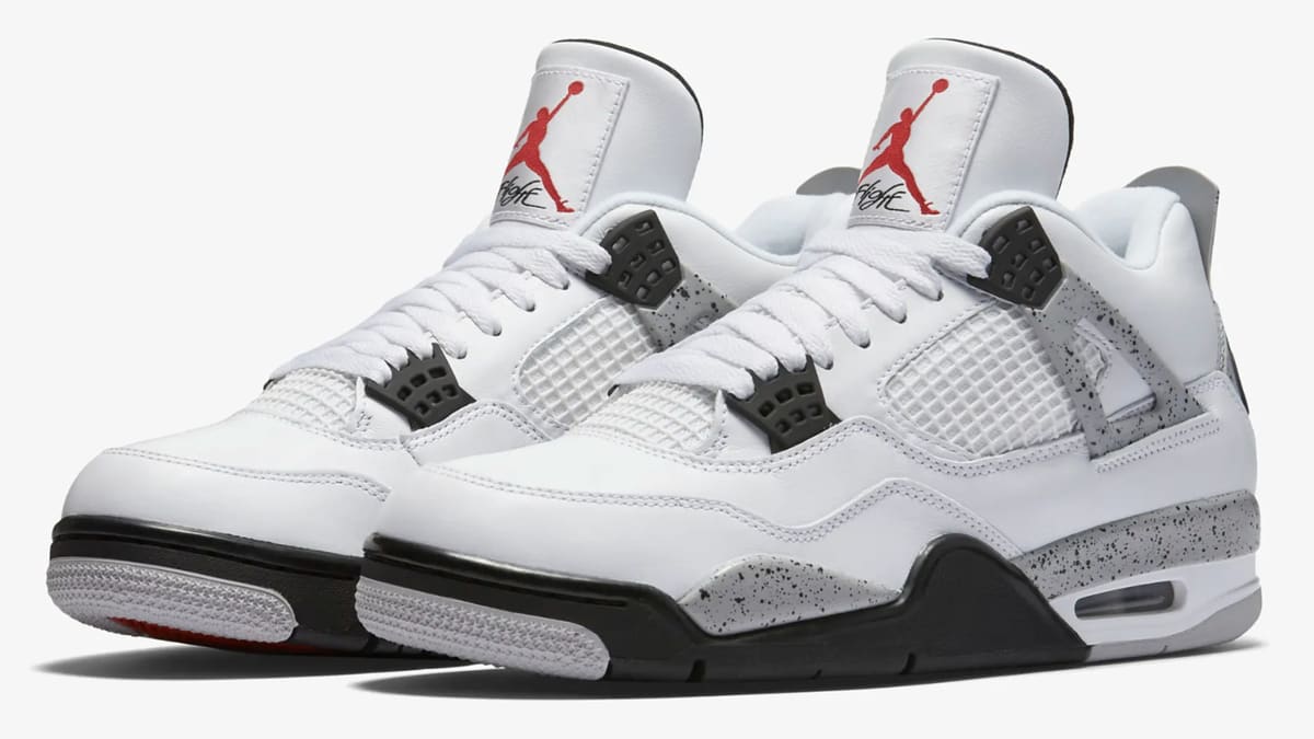 A pair of white Air Jordan 4 Retro sneakers with black and gray accents. The shoes feature the iconic Jumpman logo on the tongue