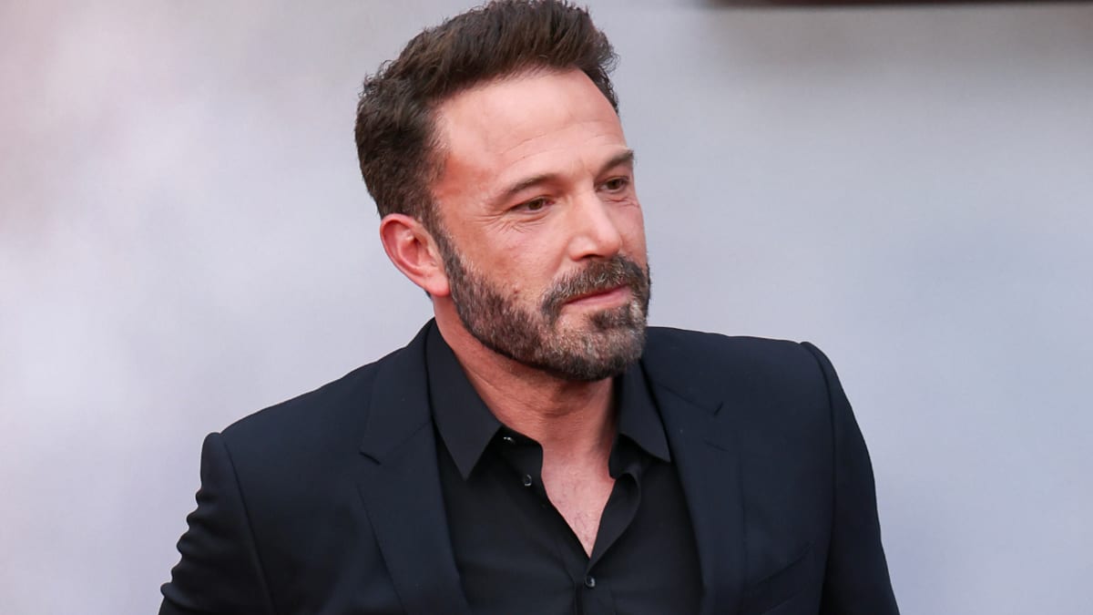 Ben Affleck on the red carpet, wearing a stylish black suit and dress shirt