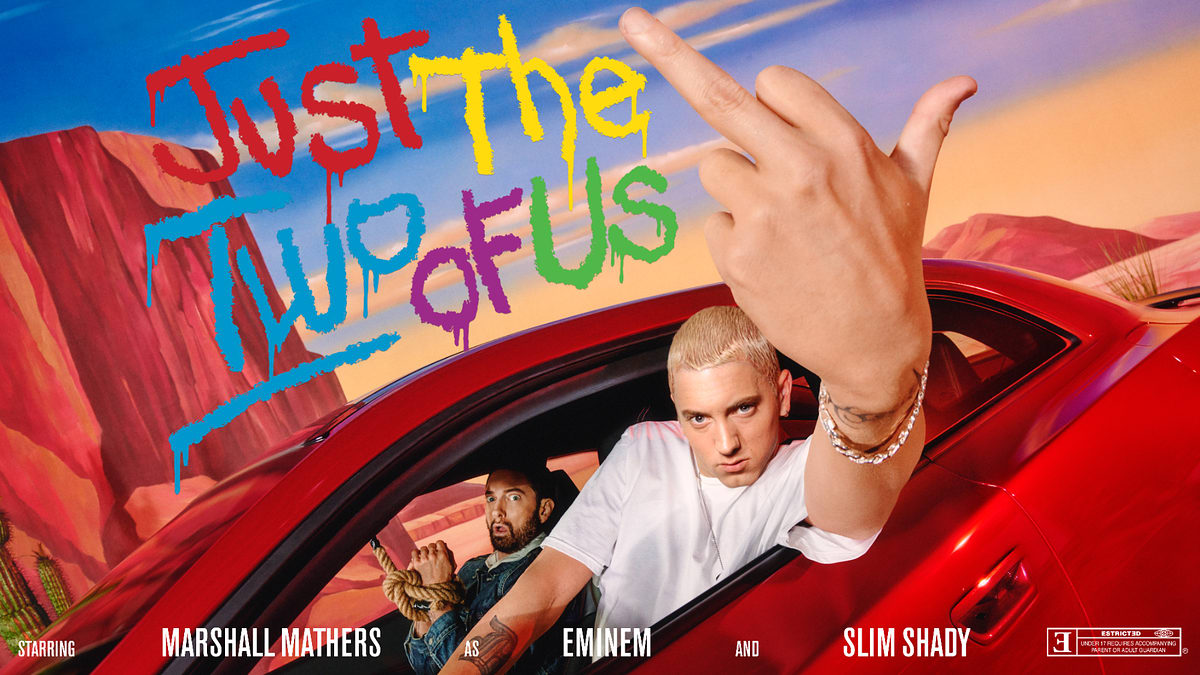 Marshall Mathers, Eminem, and Slim Shady pose in a car with "Just the Two of Us" graffiti in the background. Eminem shows his middle finger