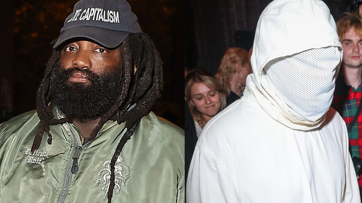 Person on the left, with long dreadlocks, wearing a "Free Capoeira" cap and green jacket. Person on the right wears a white hooded outfit covering their face