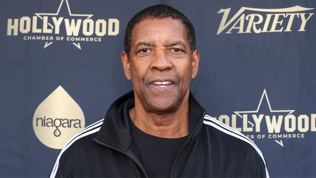 Denzel Washington in a black jacket at the Hollywood Chamber of Commerce event backdrop