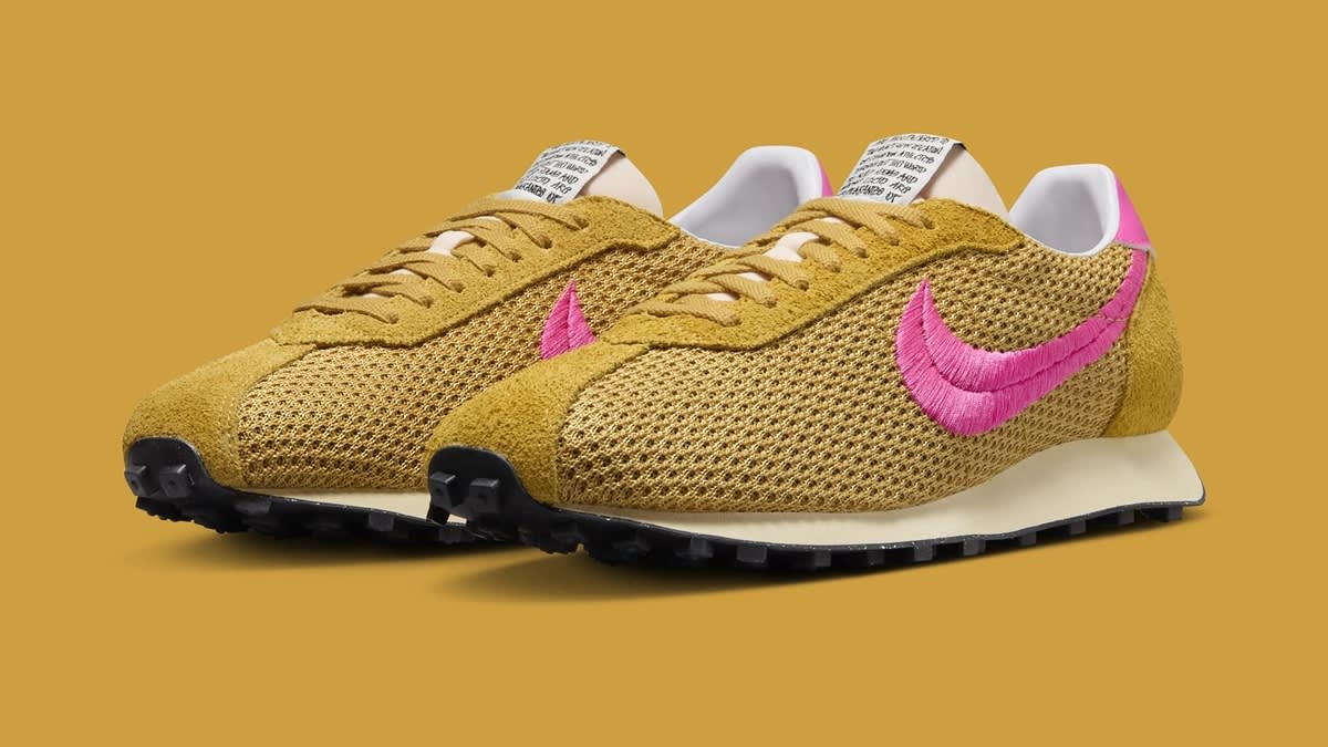Pair of Nike waffle sneakers with mesh detailing and prominent pink swoosh logos on a yellow background