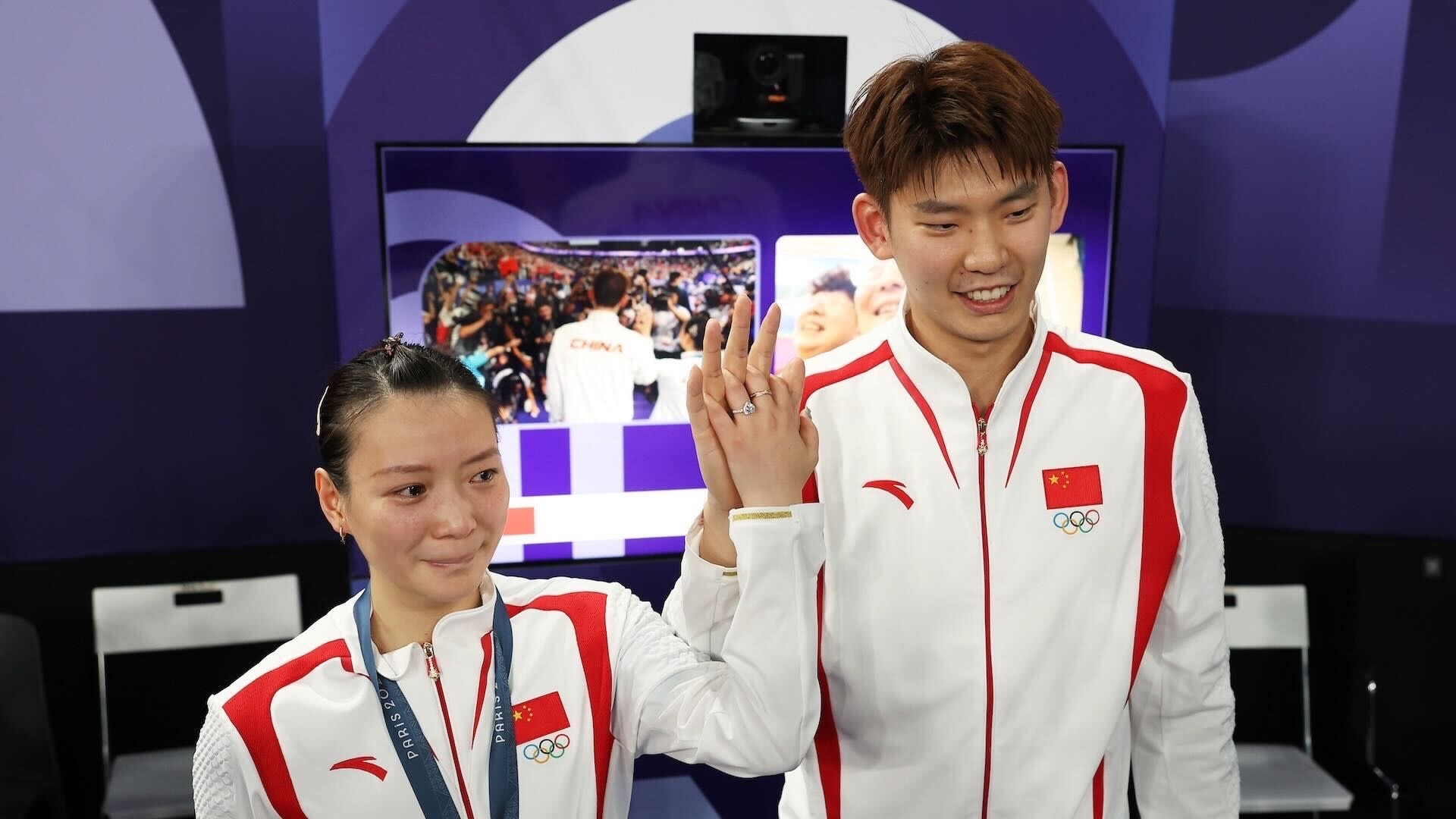 Chinese badminton players pose at award ceremony after getting engaged.