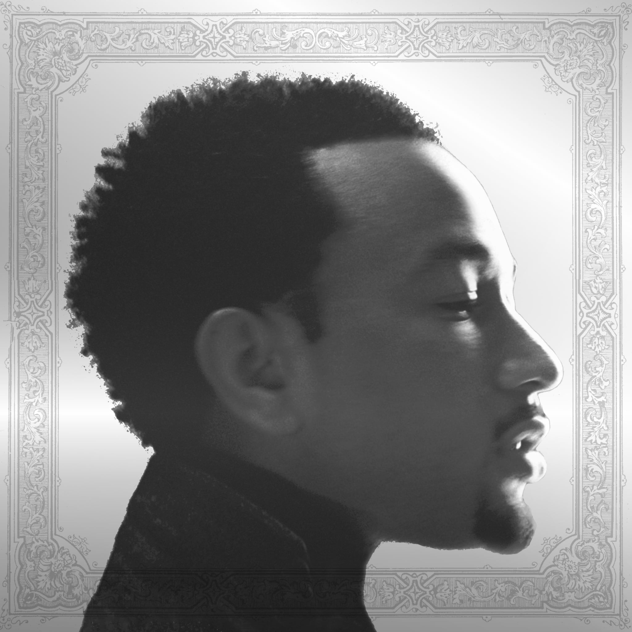 Profile of John Legend in black and white with an ornate border.