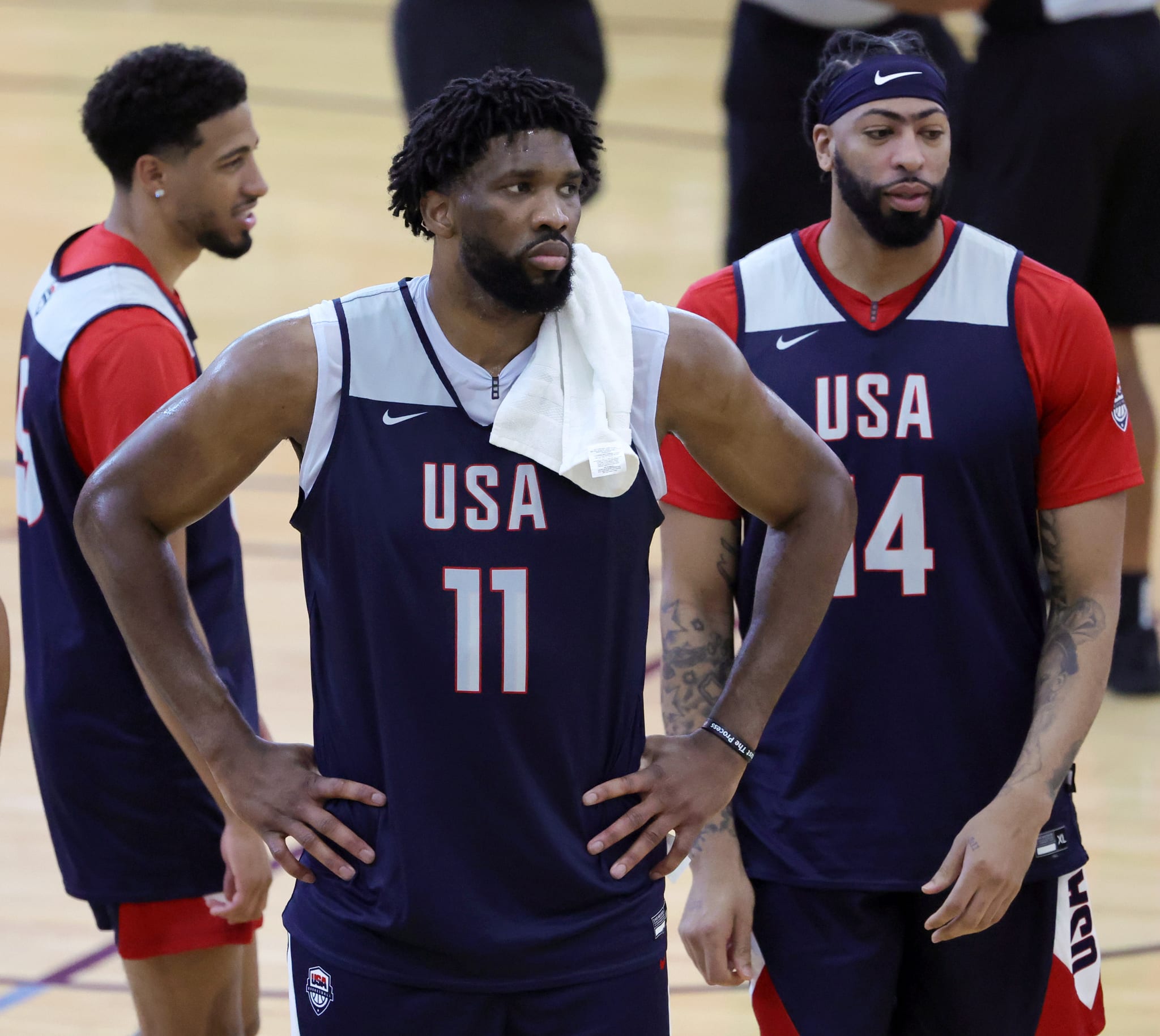 Joel Embiid, Anthony Davis, and another player wearing "USA" basketball jerseys during a practice session