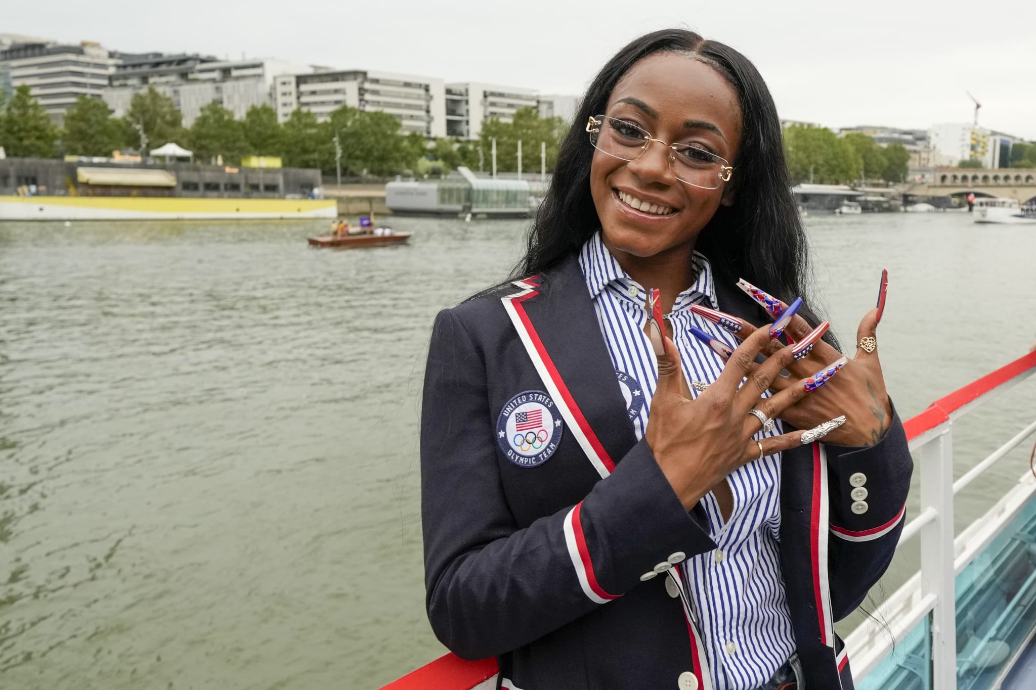 Sha'Carri Richardson poses for a photo while riding with teammates on a boat with teammates along the Seine River during the Opening Ceremony of the Olympic Games Paris 2024 on July 26, 2024 in Paris, France.