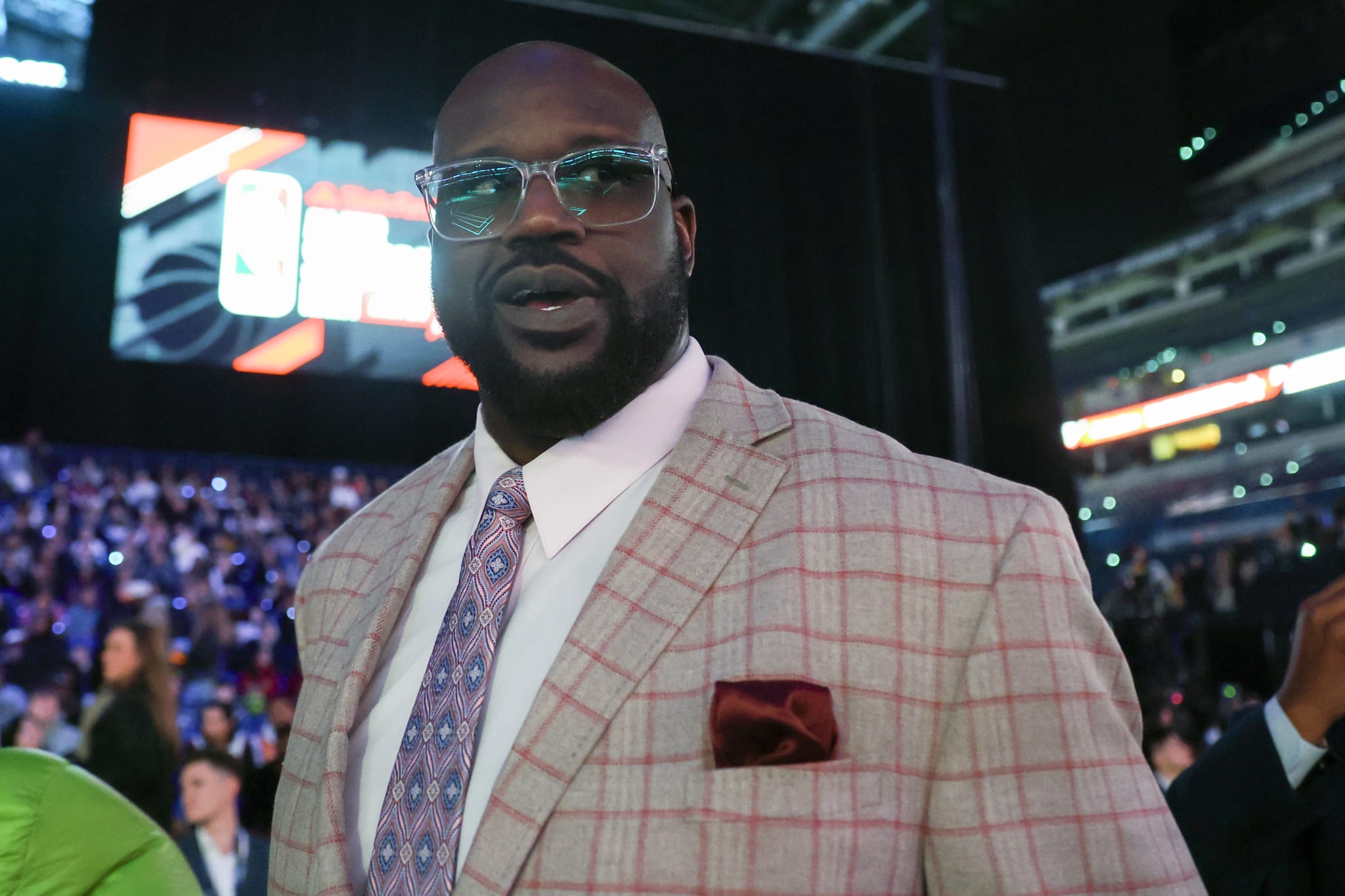 Man in a plaid suit attending a sports event