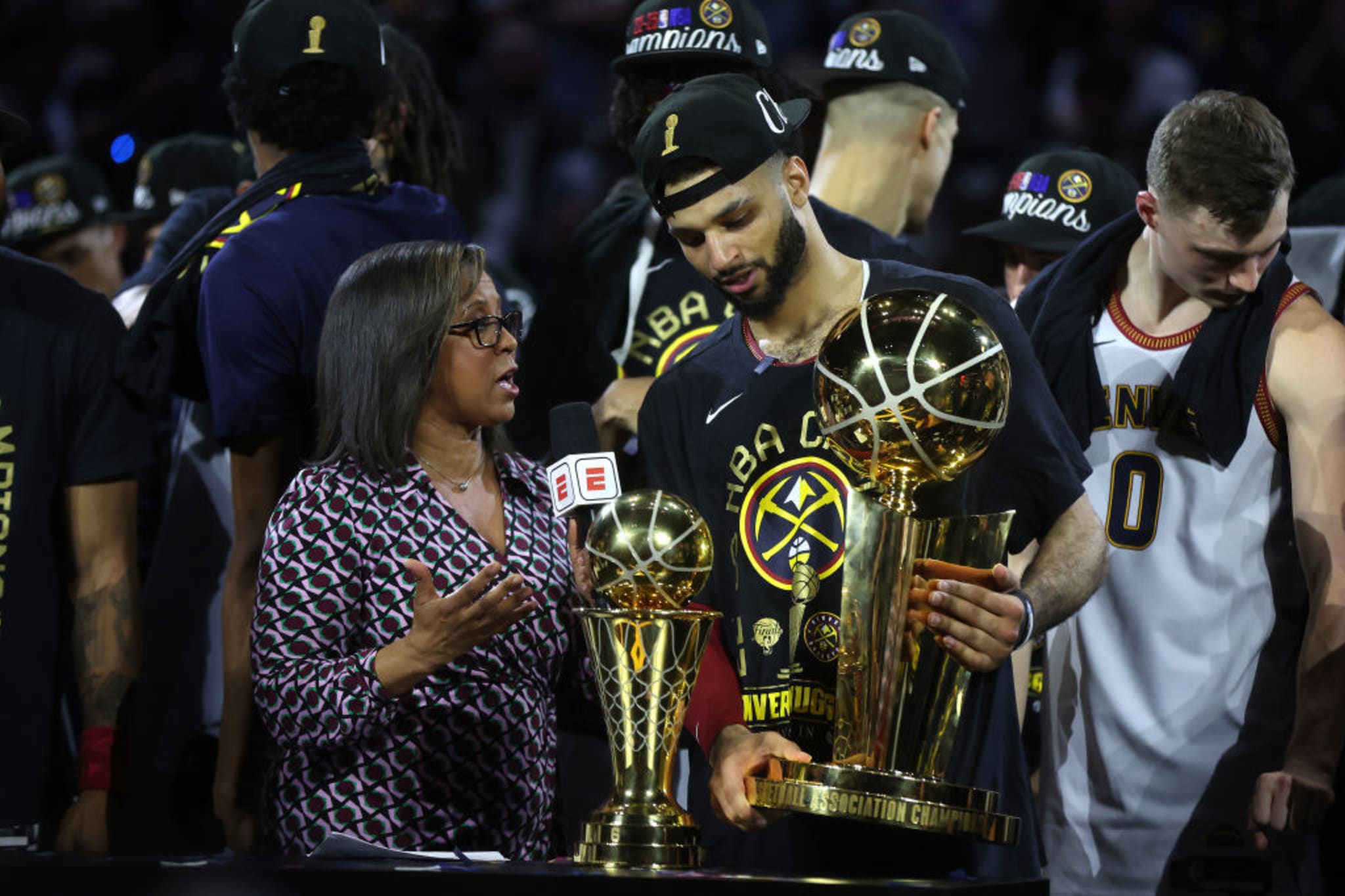 Jamal Murray #27 of the Denver Nuggets is interviewed holding the Larry O'Brien Championship Trophy