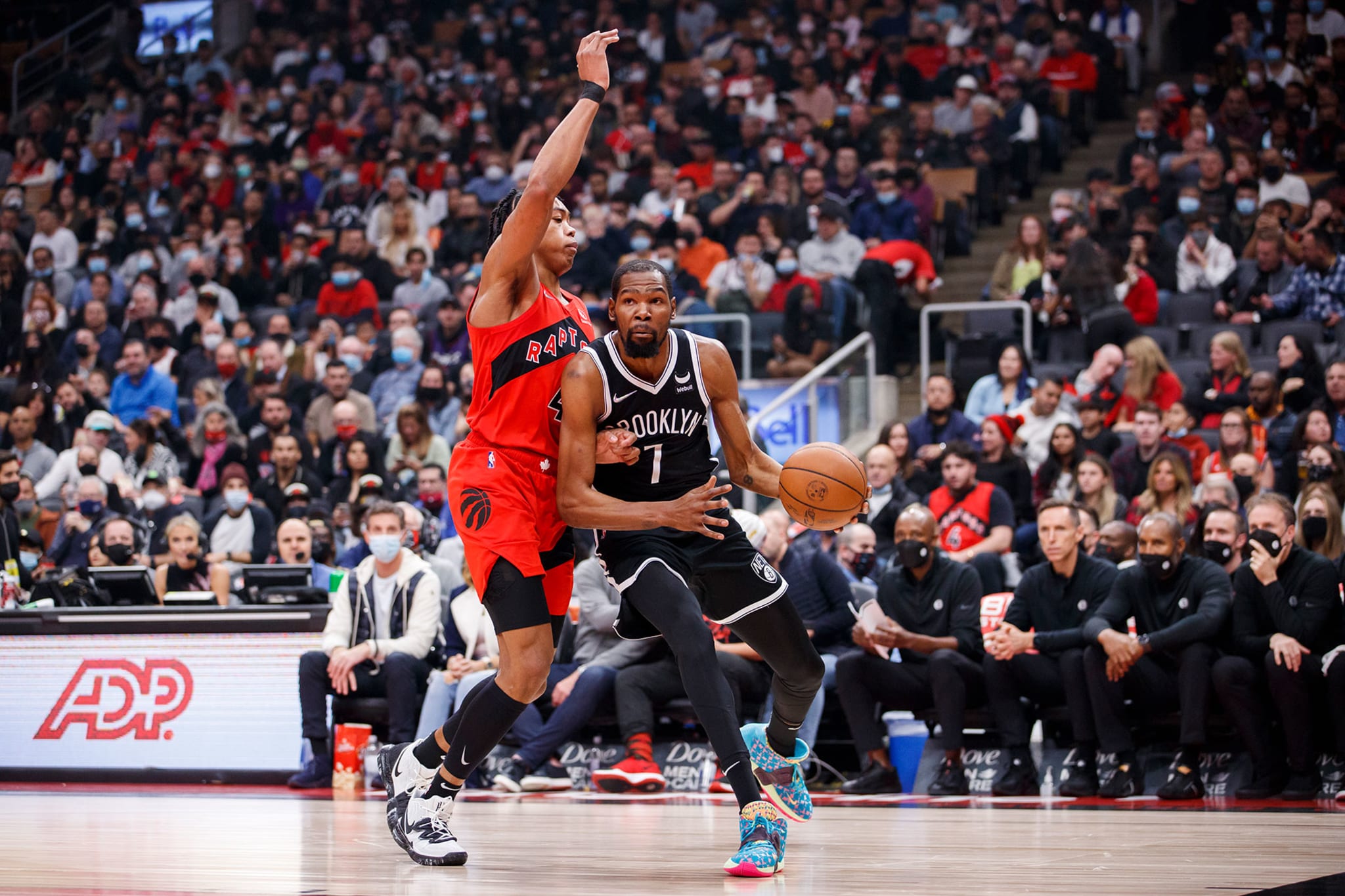 Kevin Durant #7 of the Brooklyn Nets drives on Scottie Barnes #4 of the Toronto Raptors