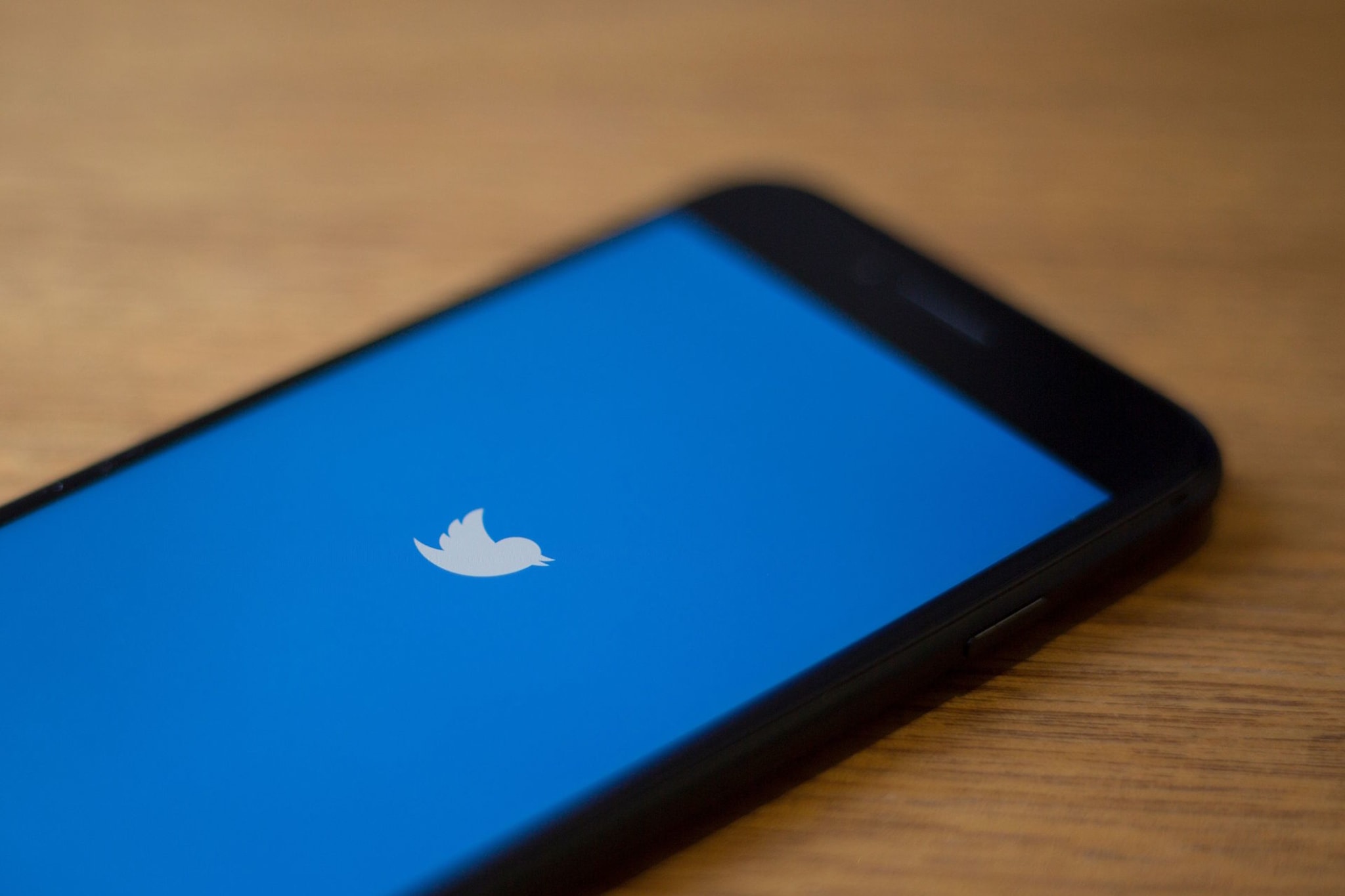 The Twitter logo is seen on a phone in this photo illustration in Washington, DC.