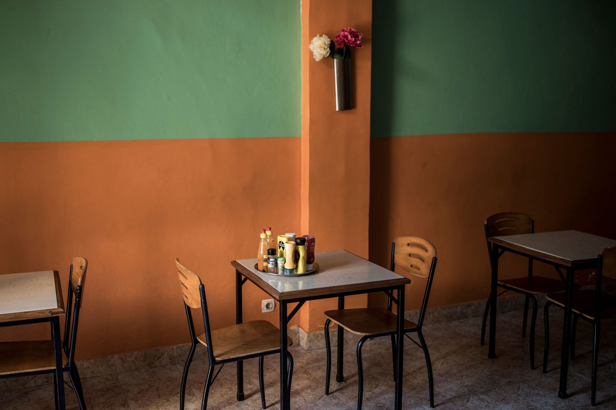 Condiments sit on a table in a restaurant in "Bissau Velho", Bissau's old city.