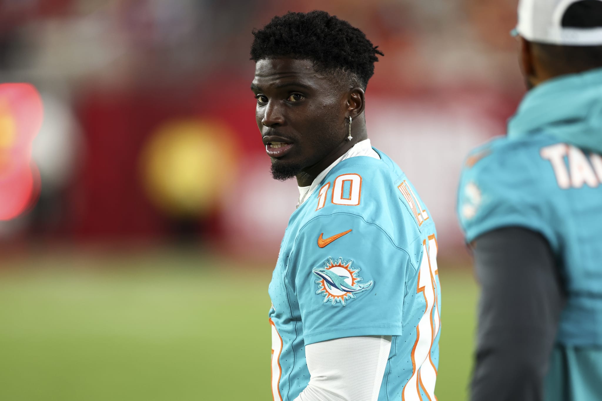 Tyreek Hill #10 of the Miami Dolphins stands on the sidelines during an NFL preseason football game against the Tampa Bay Buccaneers at Raymond James Stadium on August 23, 2024 in Tampa, FL