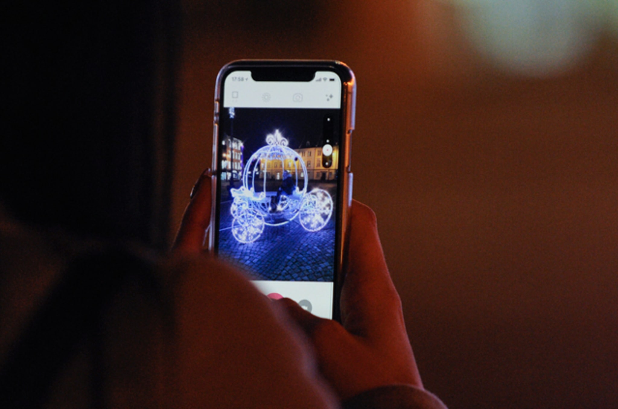 People are seen taking photos in a lit carriage on the Old Market Square in Bydgoszcz, Poland