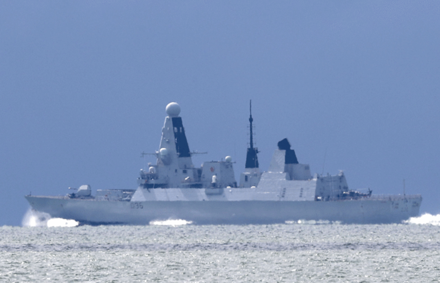 The HMS Defender passes the Isle of Wight after leaving Portsmouth Harbour.