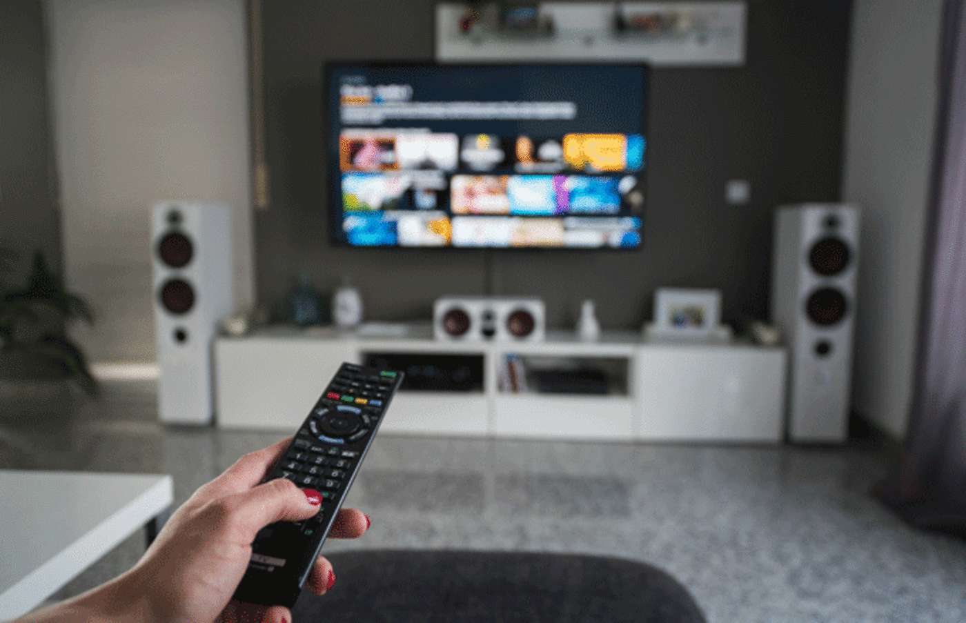 Remote control with TV in living room.