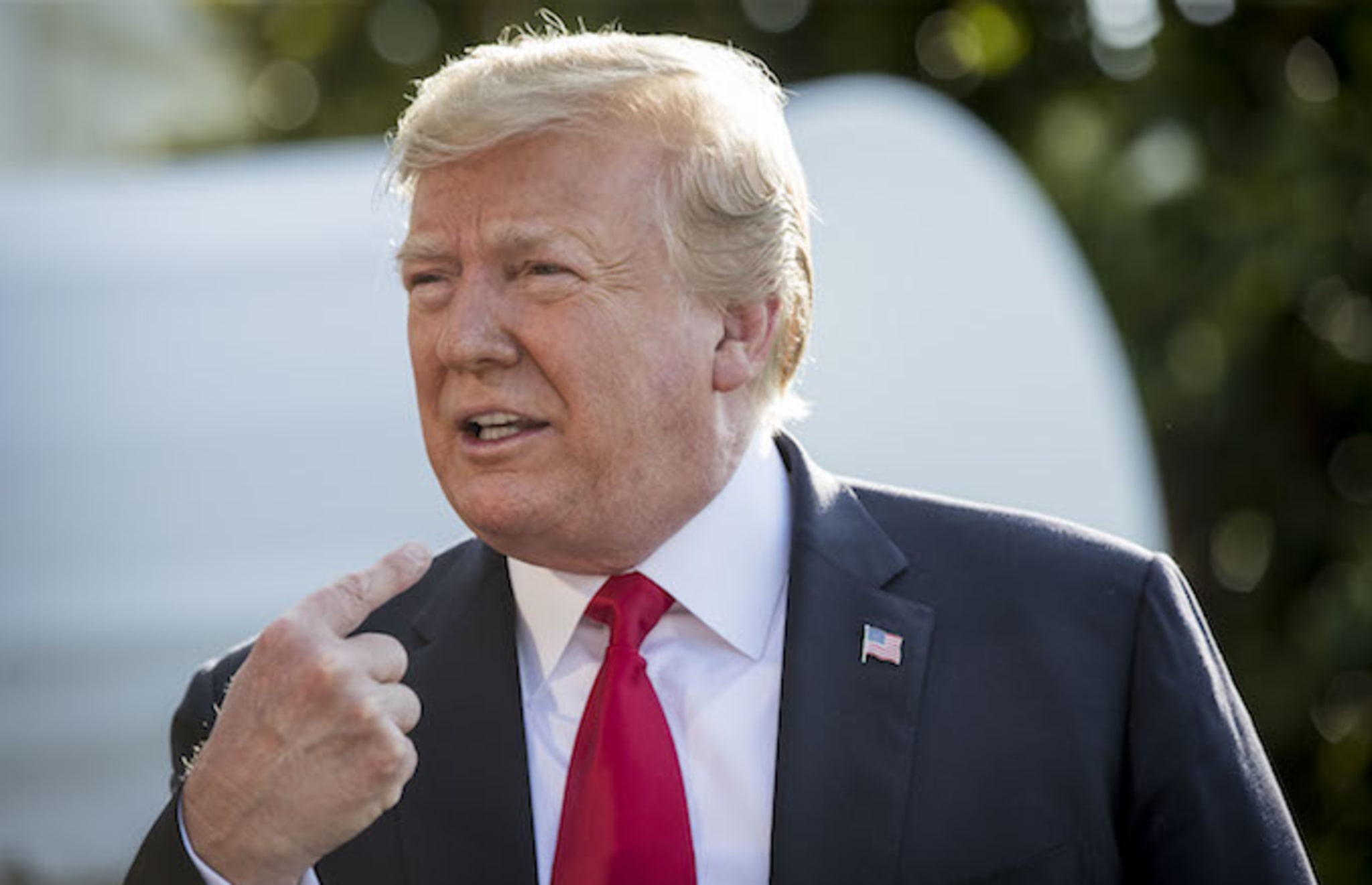 President Donald Trump speaks to the press before departing from the South Lawn of the White House.