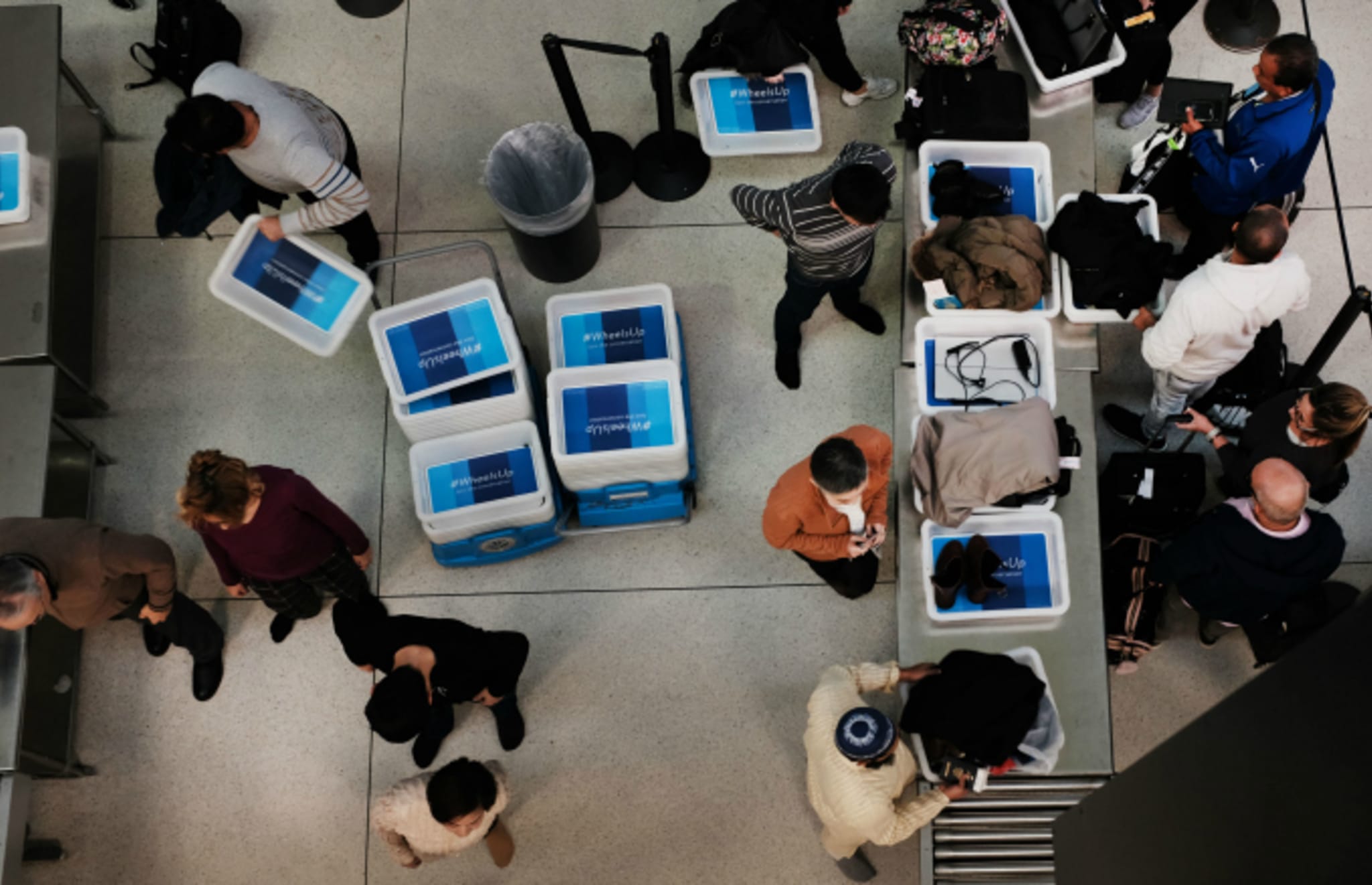 Passengers wait in a Transportation Security Administration