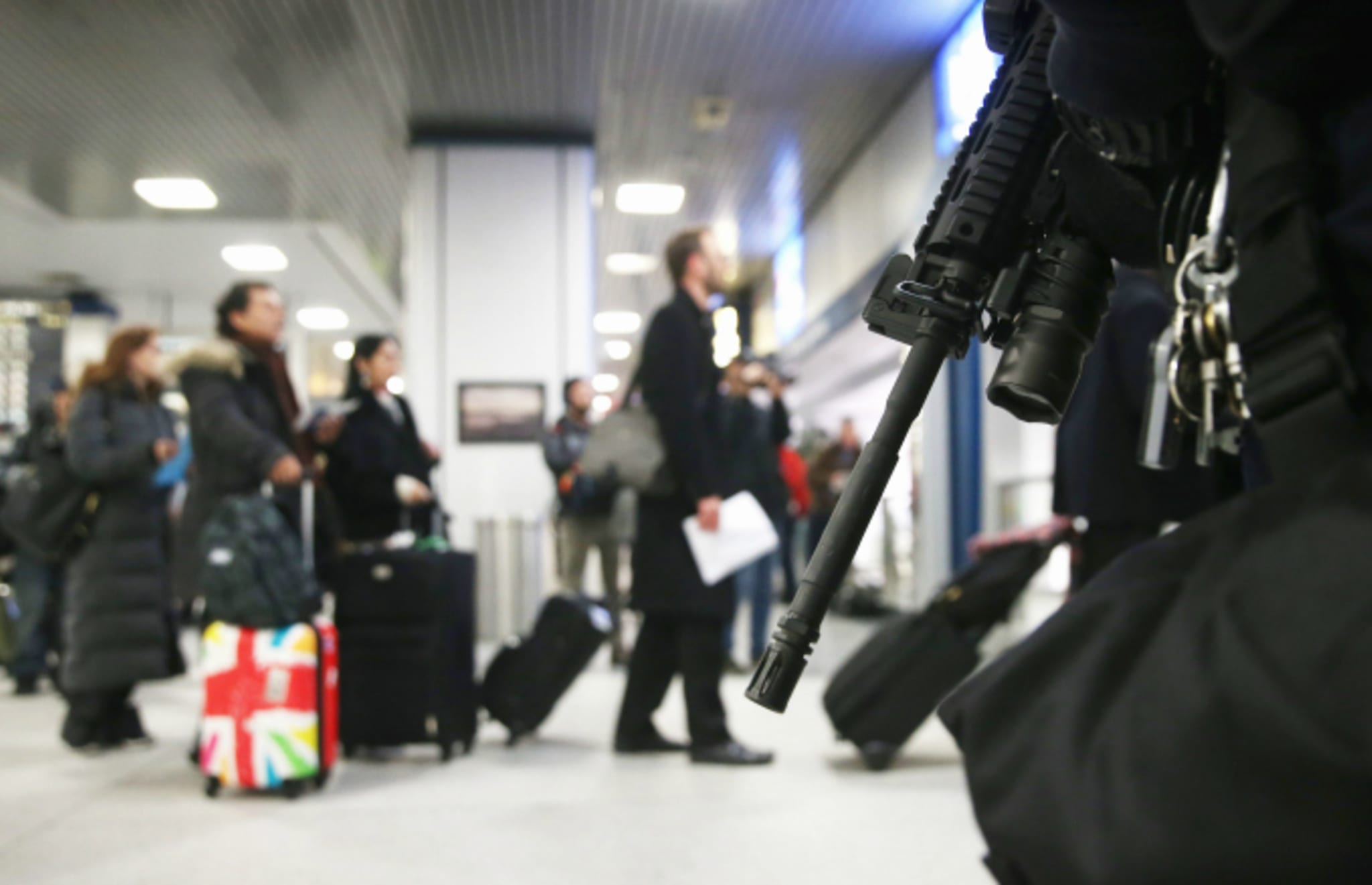 policeman standsguard with assault rifle