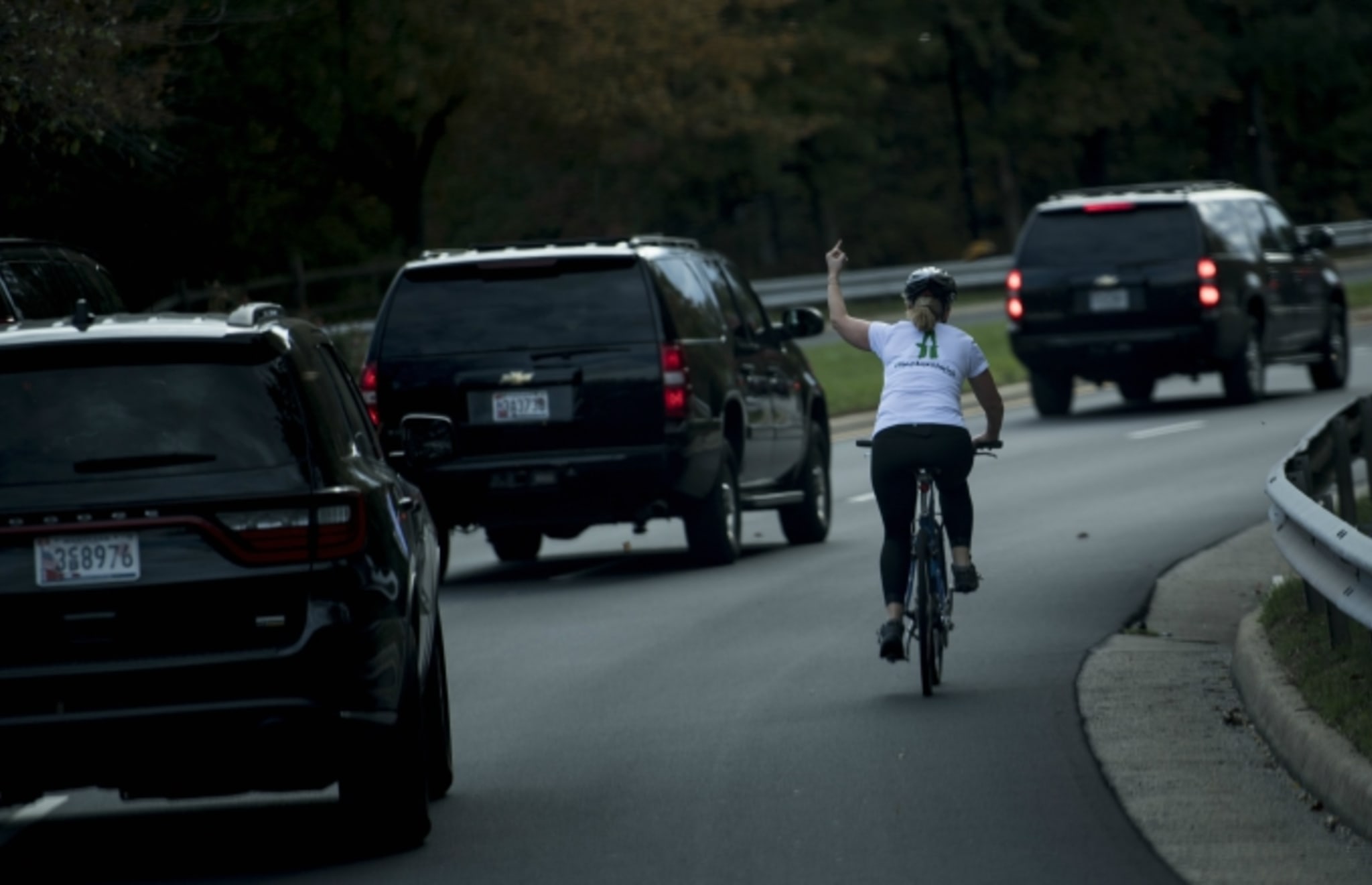 Woman gives Trump the finger.