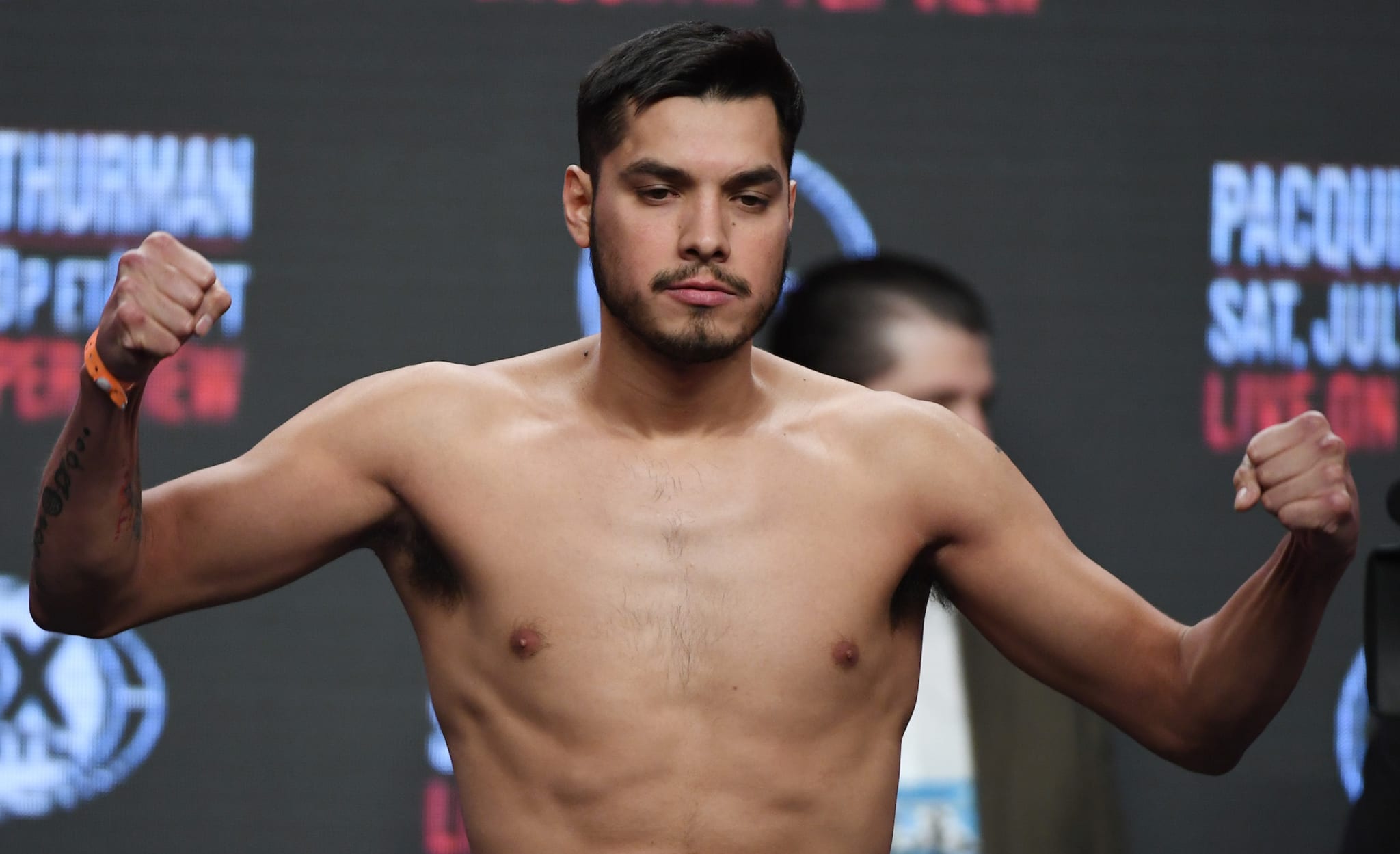 Omar Figueroa Jr poses on the scale during his official weigh-in at MGM Grand Garden Arena