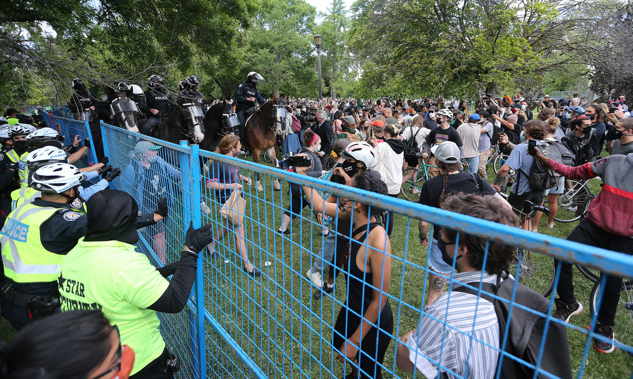 The City of Toronto with the aid of Toronto Police And Star Security erect fences around homeless encampments in Trinity Bellwoods park as the begin to remove the parks Ontario enters Step One of a three step reopening plan as COVID-19 vaccinations rise and new cases continue to fall in Toronto. June 22, 2021.