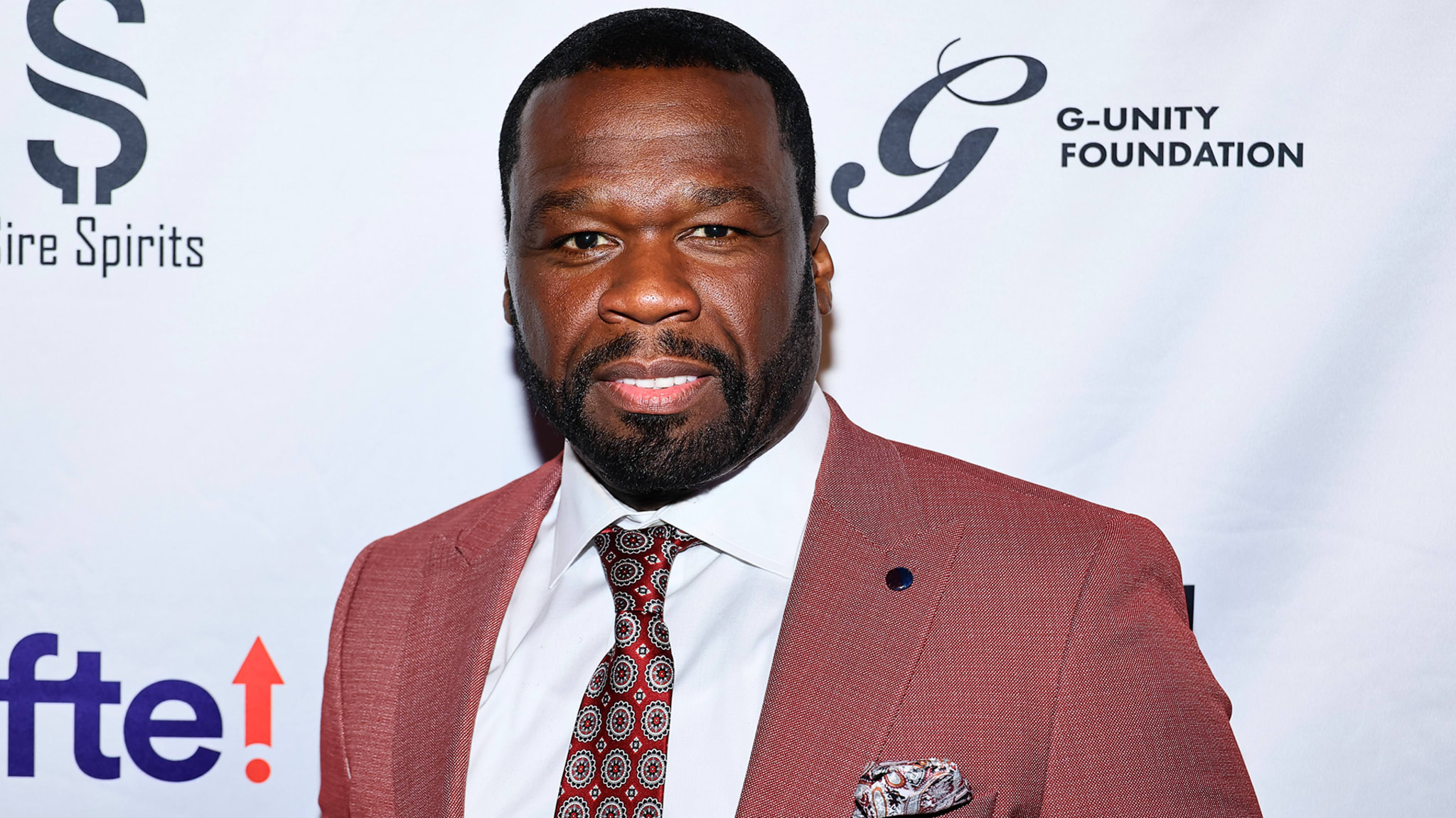 Man in textured suit with tie at an event
