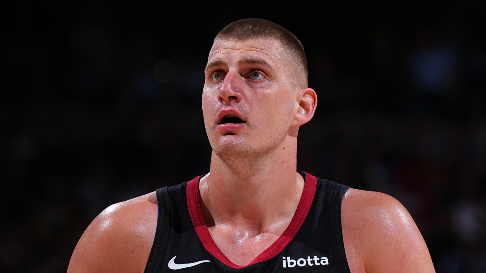 Basketball player on the court in a focused stance during a game