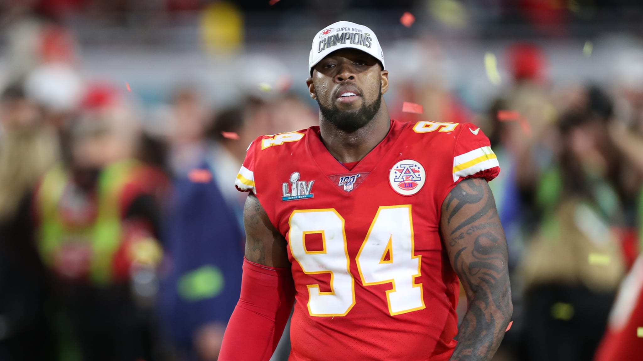 Kansas City Chiefs player in jersey number 94 on the field with "Champions" patch