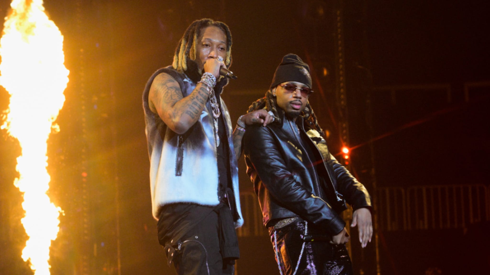 Future and Metro Boomin on stage performing with pyrotechnics in the background