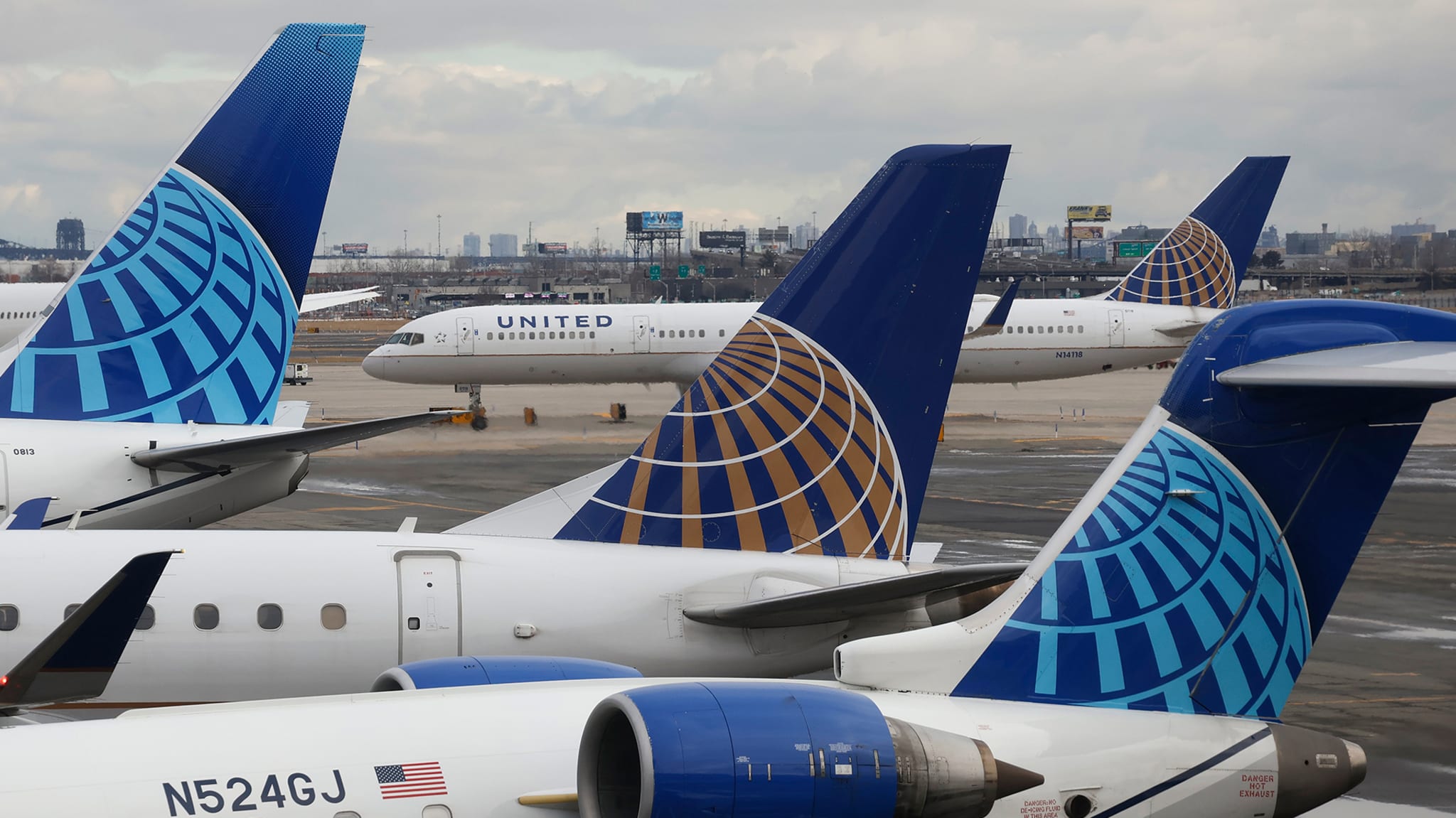 United Airlines aircraft tails with company logo at airport; another plane taxiing in background