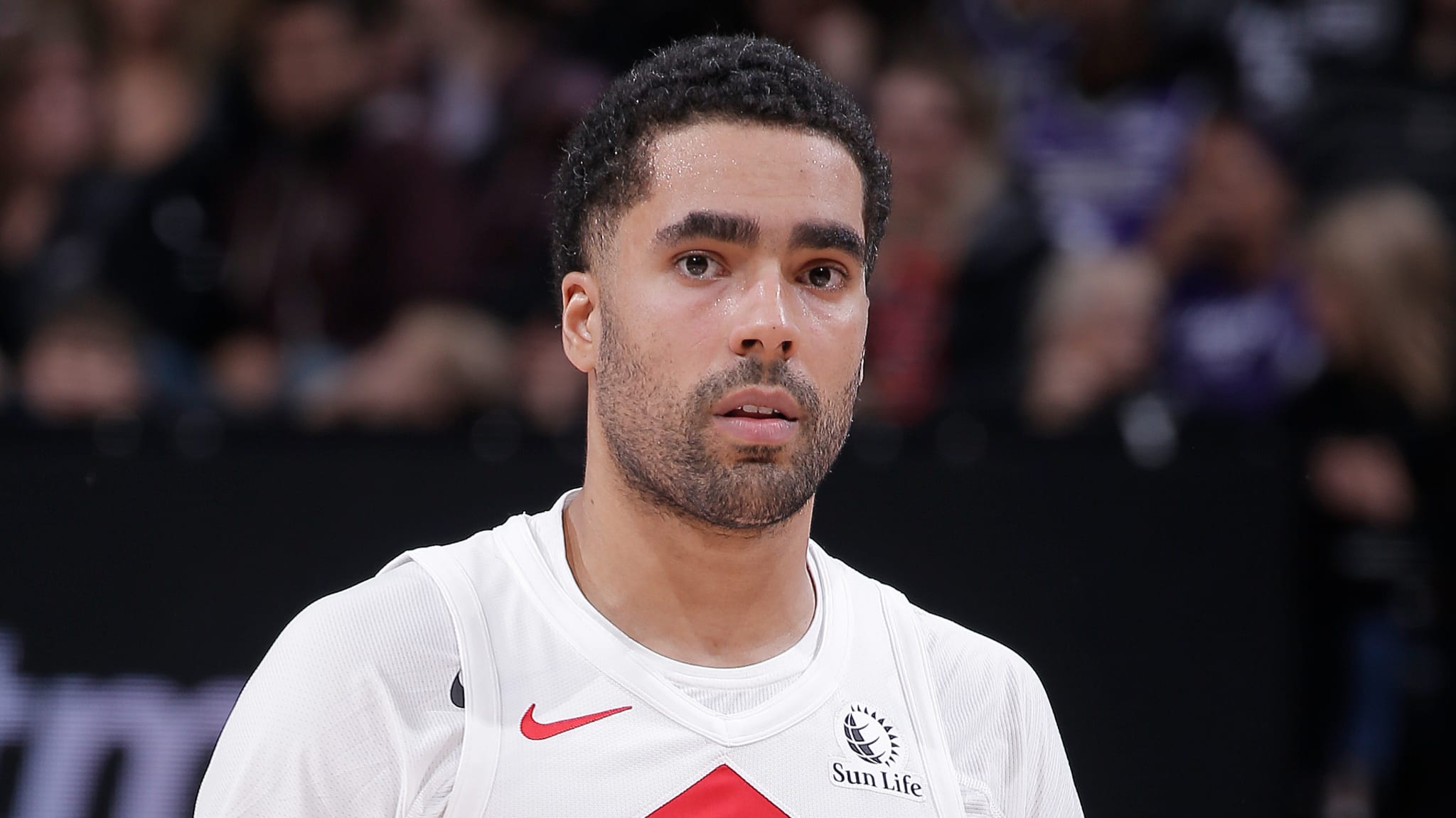Basketball player in white jersey focused during a game. No names provided; cannot specify identity
