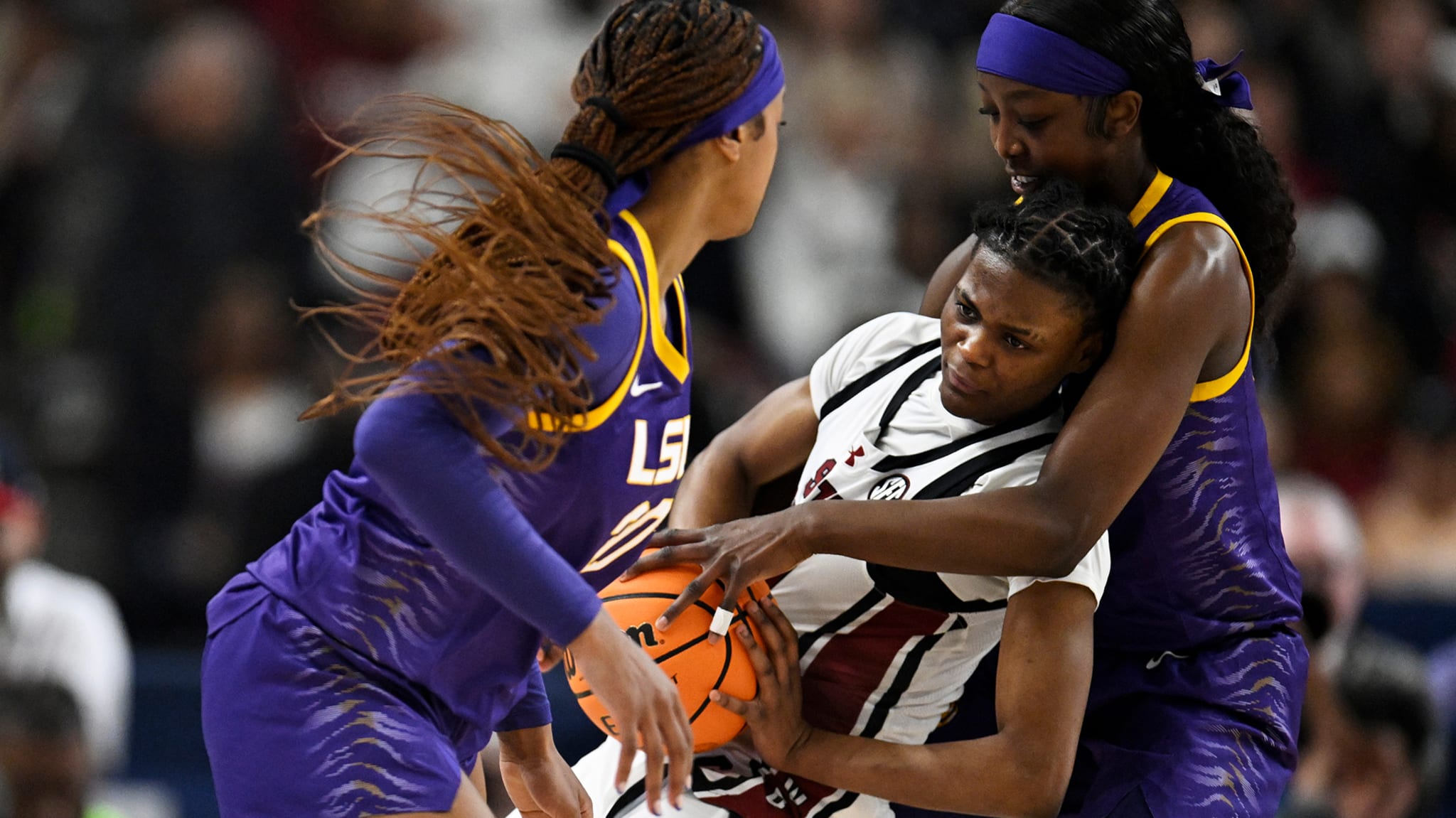 Flau'jae Johnson #4, Janae Kent #20 of the LSU Lady Tigers, and MiLaysia Fulwiley #12 of the South Carolina Gamecocks.