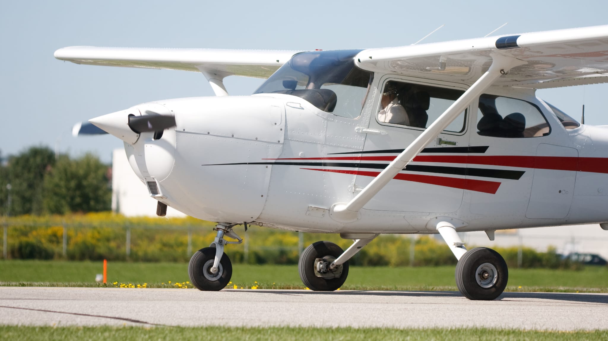 A small plane is pictured at an airport