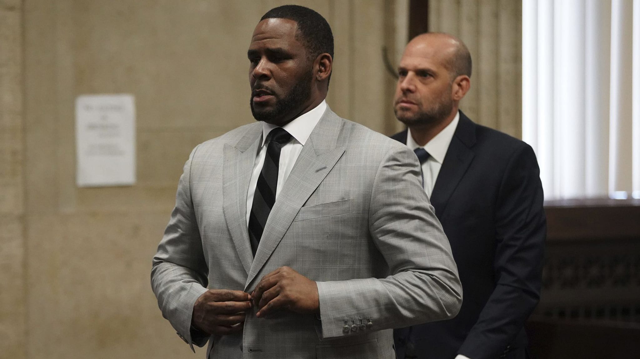 R. Kelly stands in court before Judge Lawrence Flood at Leighton Criminal Court Building
