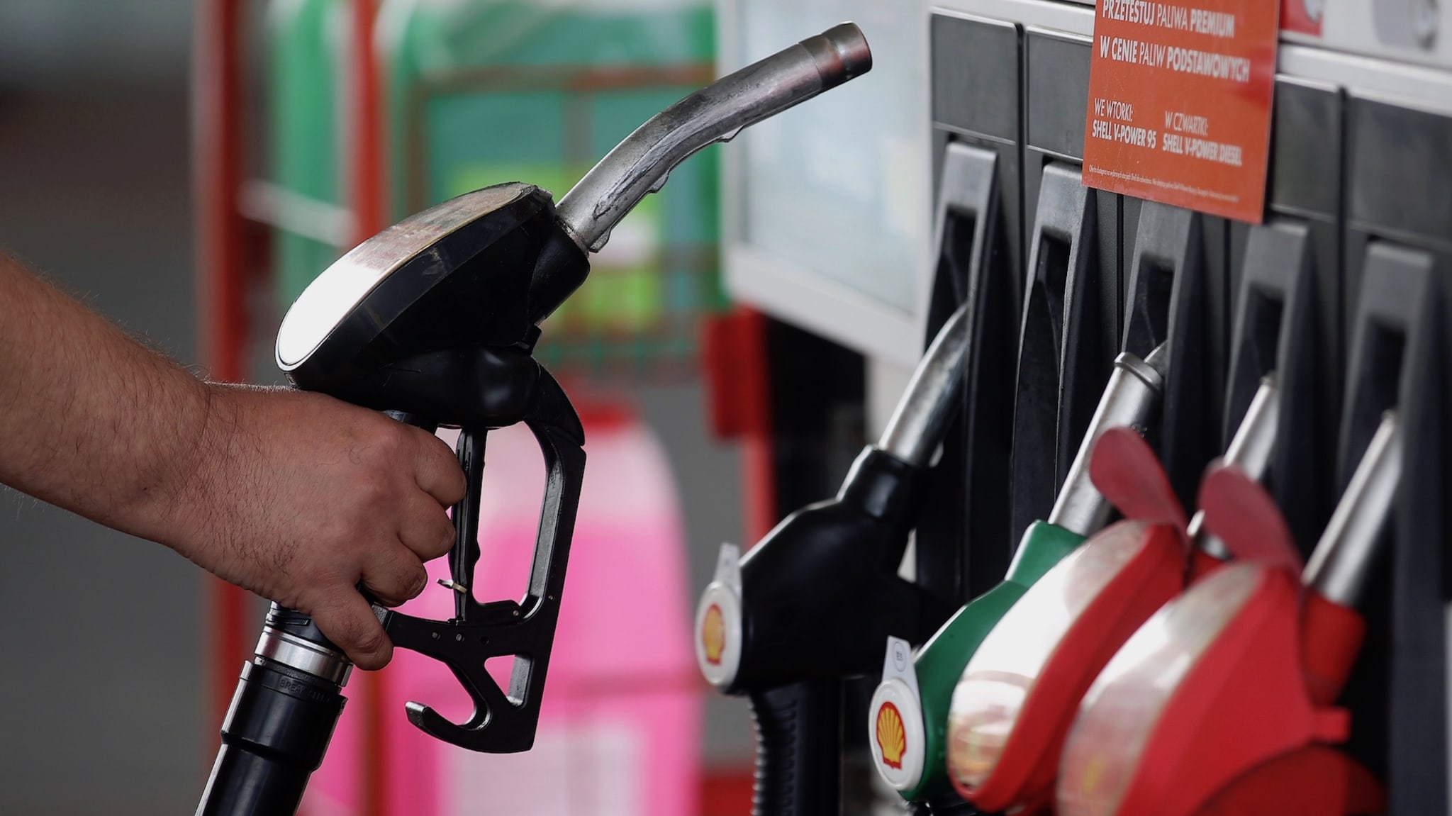 Shell gas station worker uses fuel distributor