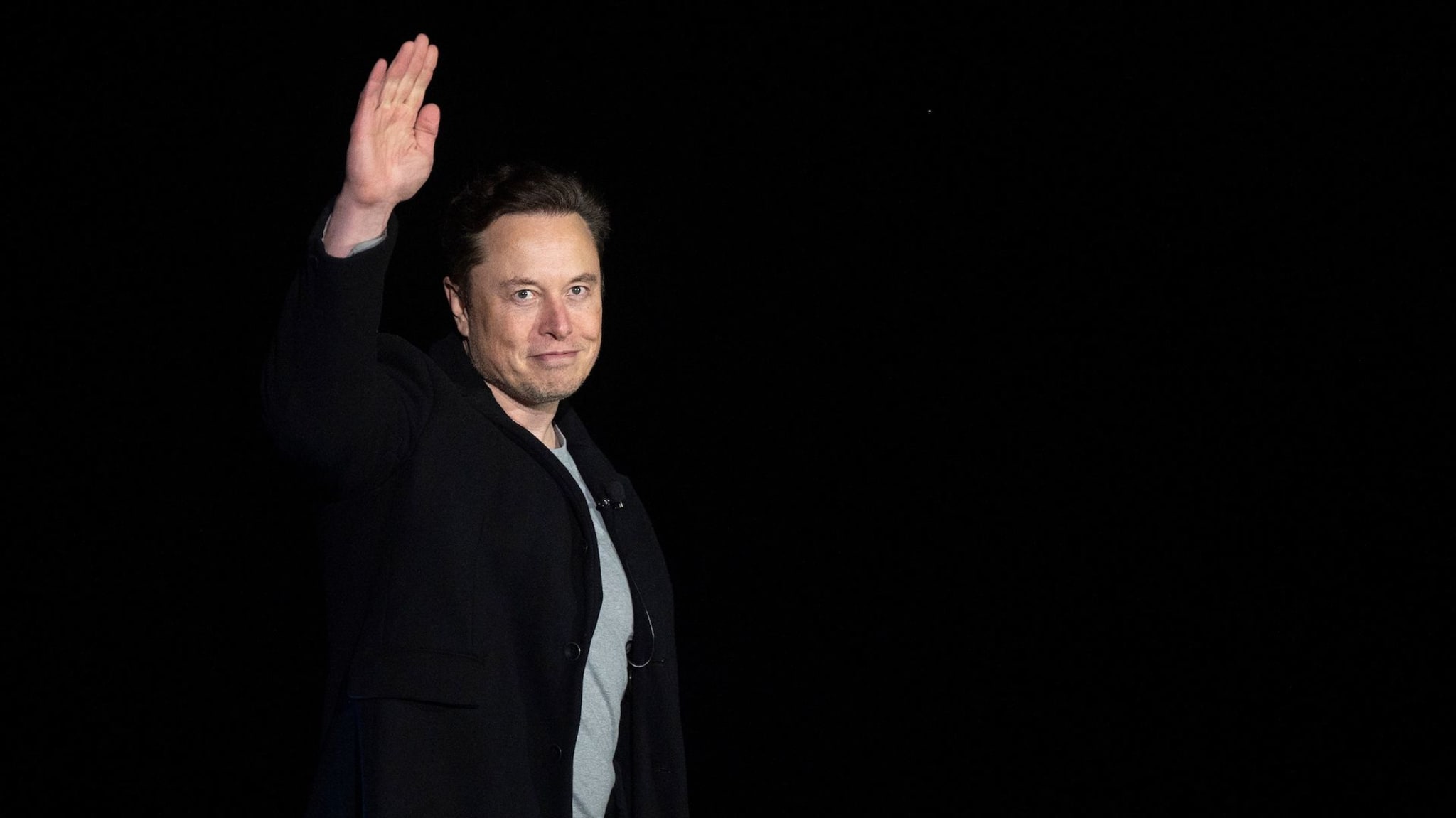 Elon Musk gestures as he speaks during a press conference at SpaceX's Starbase facility