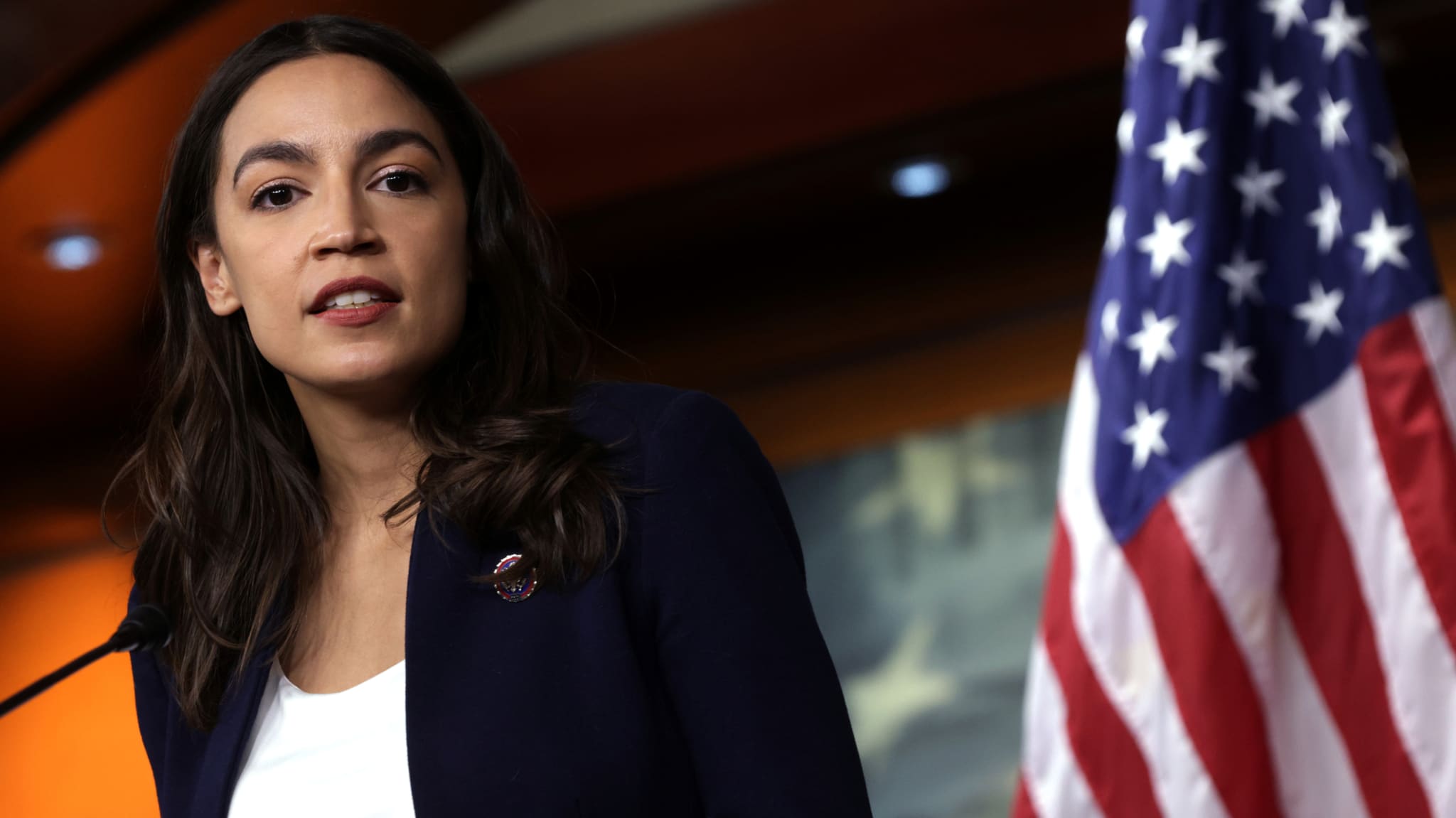 Alexandria Ocasio Cortez is pictured speaking at a podium