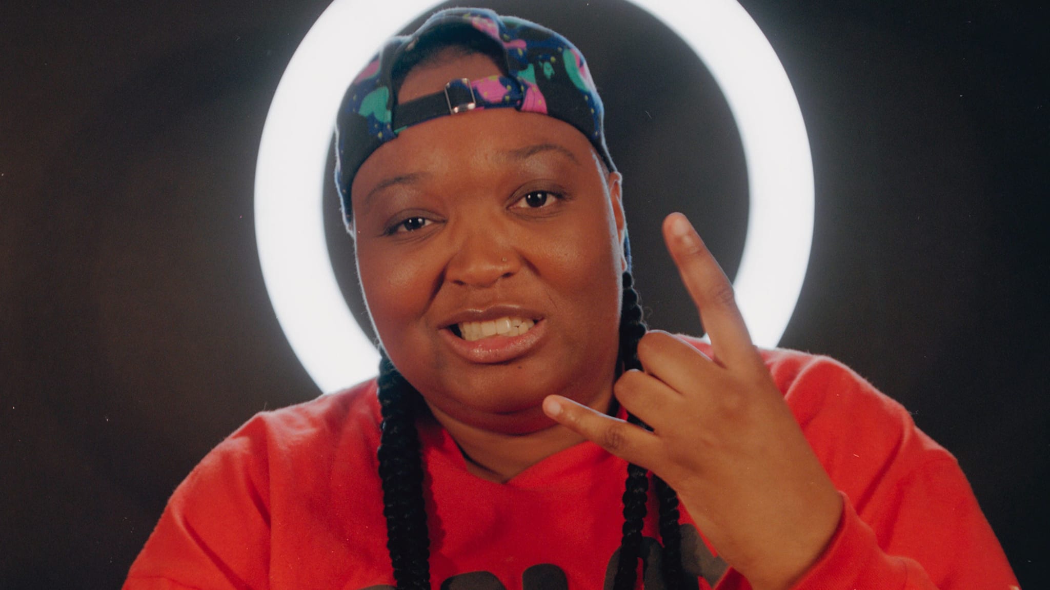 Toronto rapper DijahSB does metal hand sign in front of ring light