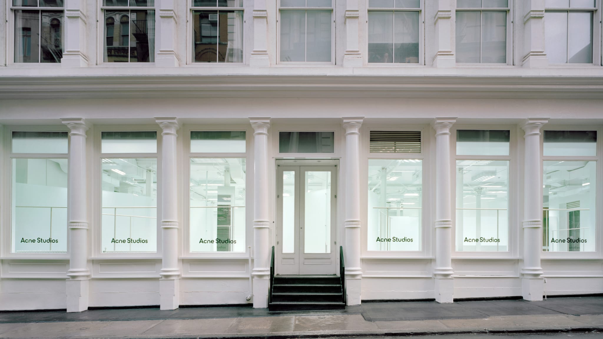 A photo of the new Acne Studios space is shown.