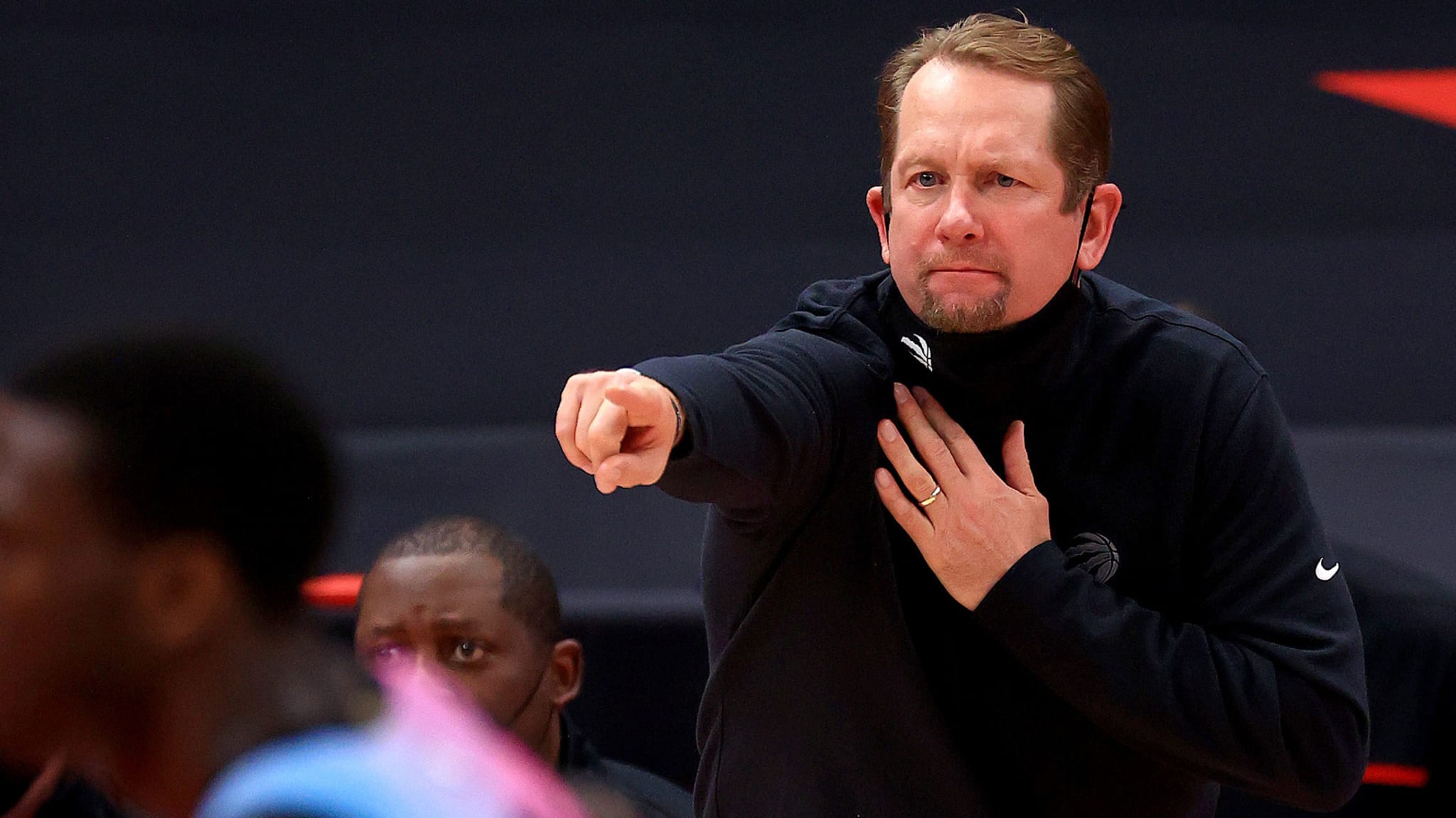 Nick Nurse pulling down mask during Raptors game