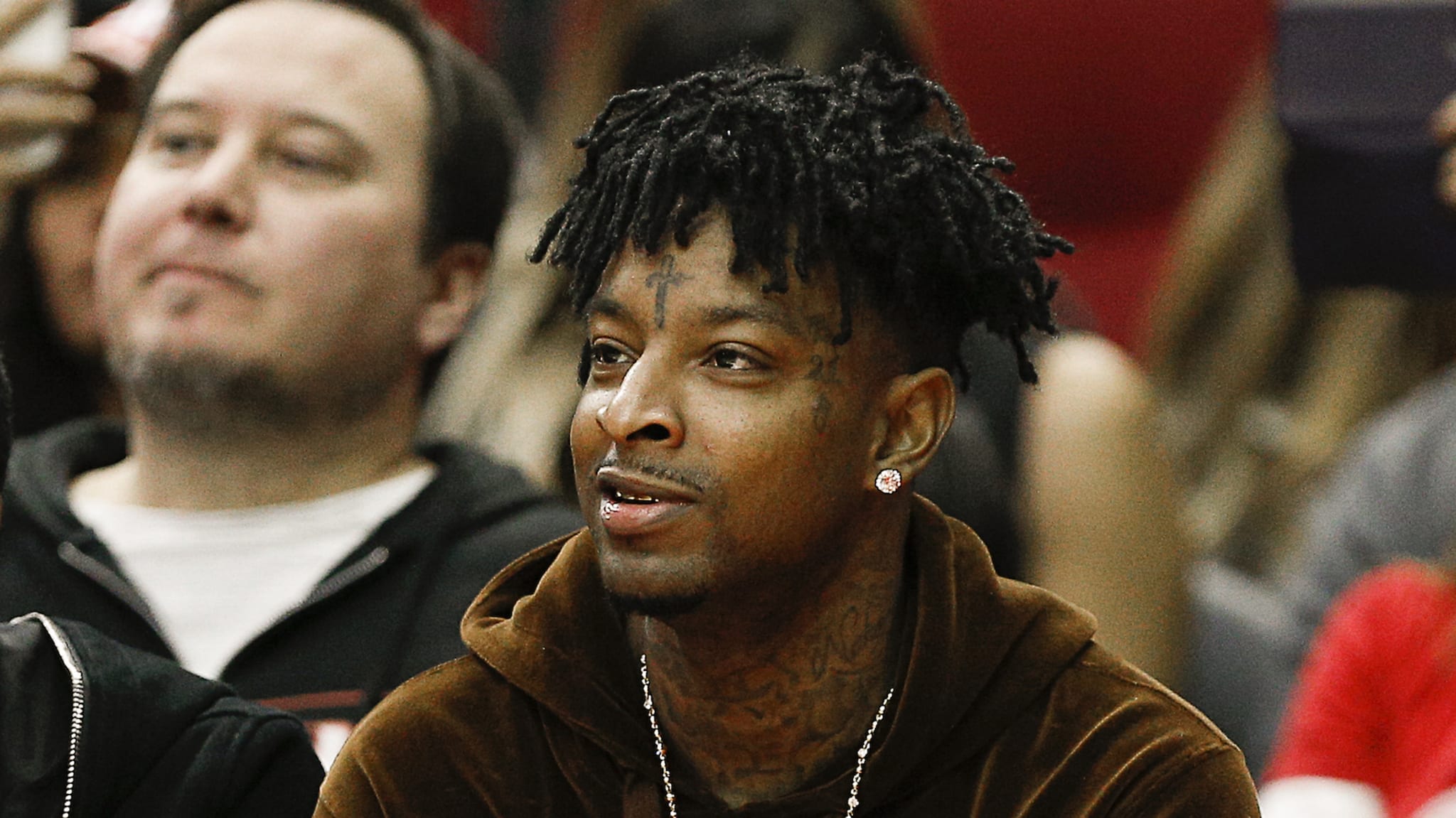 21 Savage watches from court side as the Denver Nuggets played the Houston Rockets