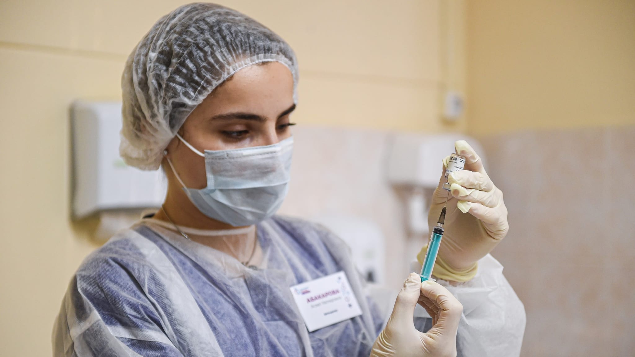 Russian woman administering Sputnik V vaccine