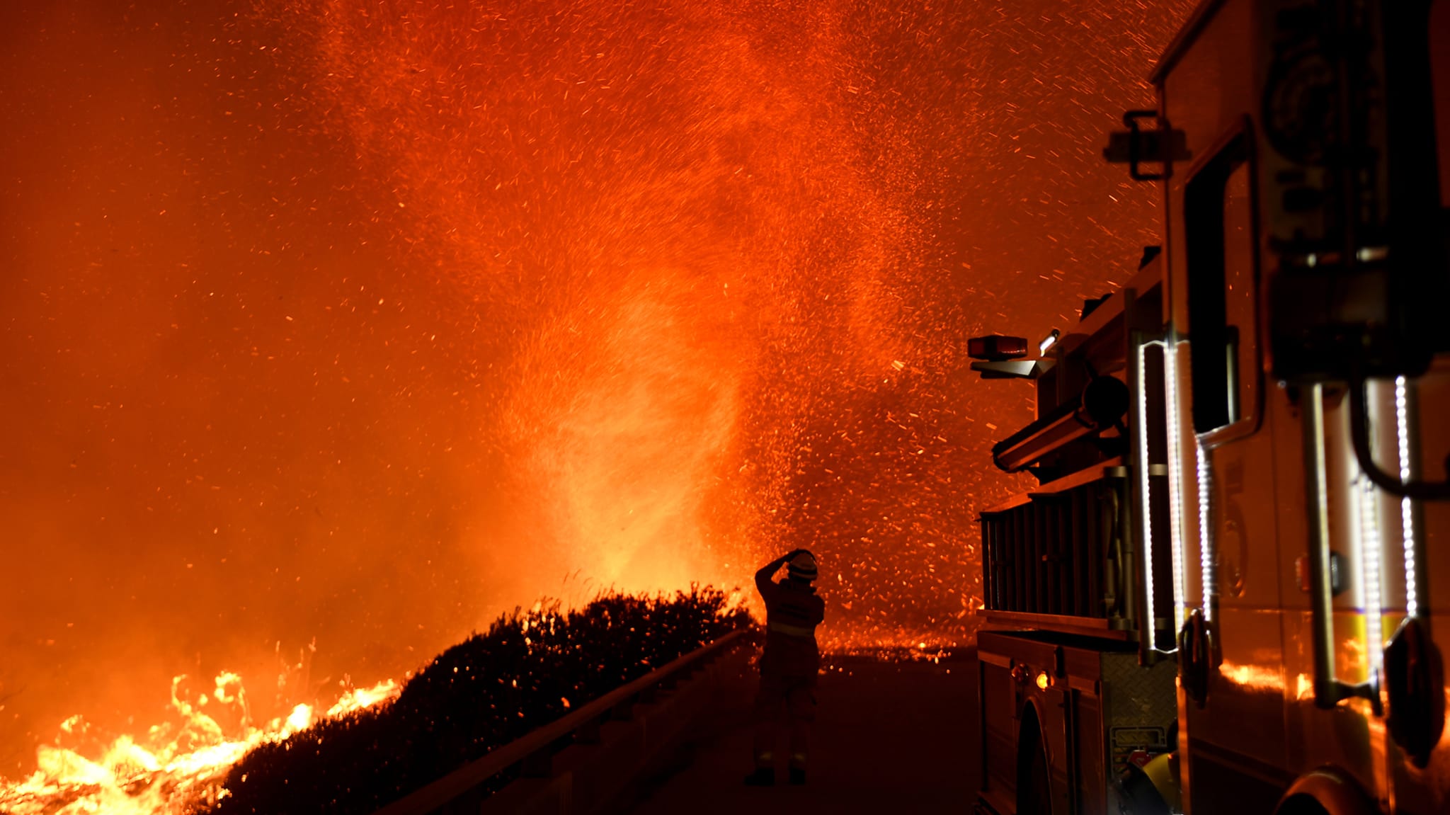 California firefighter watching fire tornado.