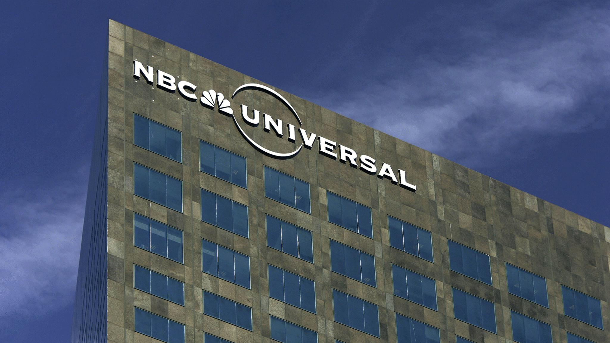 NBC Universal logo hangs on its headquarters.