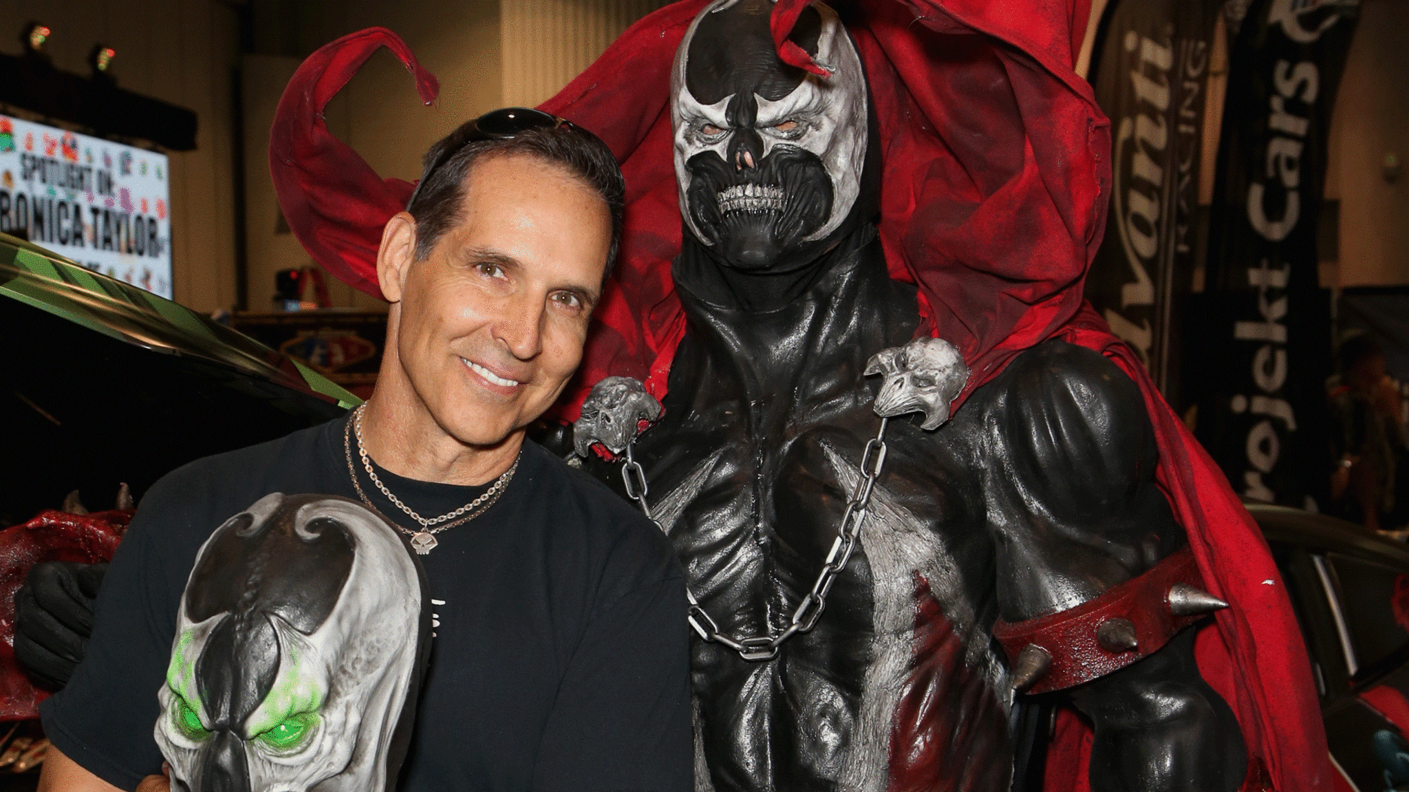 Todd McFarlane poses with a Spawn statue.